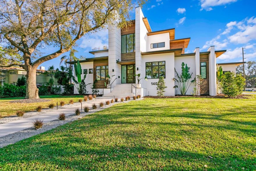 Welcome to this extraordinary newly constructed modern masterpiece in Snell Isle. The stunning, fortified, waterfront estate was completed in July 2024 by JR Structures Custom Builders, built to the newest codes and featuring elevated FEMA compliance, state-of-the-art design, energy efficiency, refined appointments and finishes throughout. Positioned on an oversized 0.41-acre corner lot enjoy water views, a new 125-foot seawall, saltwater pool and floating spa, cabana and outdoor kitchen. A full-service composite dock and 10k boat lift provides easy access to Tampa Bay. Appointed with IPE Brazilian hardwood throughout a stunning light-filled open floor plan, a gracious open foyer entry invites you to a living room that boasts soaring ceilings (12 foot) and exposed wood beams, statement lighting and expansive sliding glass doors that seamlessly blend the indoor and outdoor living areas. This one-of-a-kind modern coastal design captivates on the first level that delivers a dramatic floating staircase and formal dining room accented by a wine wall focal feature. An open chef’s kitchen provides for elevated entertaining with dual islands and quartz waterfall countertops, top-of-the-line Wolf and Sub-Zero appliances, full-size Sub-Zero beverage refrigerator, butler’s pantry and additional walk-in pantry. The first level primary suite offers a true escape that includes a sitting area and expansive window wall, automated shades, dual custom walk-in closet, laundry and spa-inspired bath that exudes elegance in the floating his/her vanities and a marble wet-room with soaking tub. Additional first level living areas include an inviting breakfast area with floor-to-ceiling windows, office, powder bath, laundry room and mudroom. Transition to the second level via an elevator or staircase to the media-ready open great room that offers terrace access via expansive sliding glass doors, along with three generous ensuite guestrooms. Additional appointments include a dog-wash station in the expanded laundry room, 24KW Generator, tankless water heater, water purification system, 4-car garage. Enjoy the very best of Florida living with expansive terraces, numerous covered entertaining areas manicured grounds and irrigation system. In close proximity to Vinoy Golf Course and Downtown St. Petersburg, enjoy endless recreation on and off the water, North Shore Park, shopping and dining. Have the very best of exceptional waterfront living with easy access to award-winning beaches, built to elevated and exacting standards, in one of Florida’s Best Places to Live.