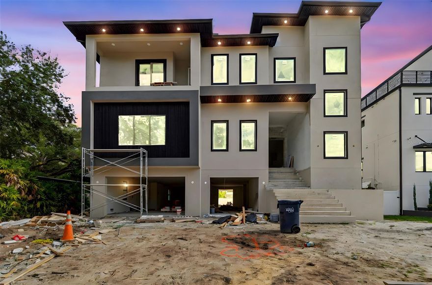 Under Construction. Built for You. Built to Last.

Two exceptional new construction homes are being offered for sale on the same street in South Tampa’s Beach Park neighborhood. The price reflects each individual residence.
204 S Occident Street delivers in March 2026; 211 S Occident Street delivers in June 2026. Both feature similar floor plans with 6 bedrooms and 7 bathrooms.

Luxury, elevation, and scale define this extraordinary multi-level new construction residence, thoughtfully designed for long-term livability and grand-scale entertaining.

The entire first level is dedicated to garage and entertainment, offering over 3,000 square feet of open, flexible space designed for hosting large gatherings, private events, or showcasing an exceptional vehicle collection. An 11-car garage anchors this level, creating a truly rare lifestyle offering in South Tampa.

A large private elevator seamlessly connects the garage level to the two upper living floors, delivering effortless access and flow throughout the home.

The main living level is designed to impress, anchored by a massive living room with tray ceilings approaching 13 feet, creating dramatic volume and light. Luxury engineered hardwood flooring runs throughout, elevating the home’s modern architectural lines. The kitchen is a true showpiece, featuring an extremely oversized island with waterfall luxury quartz and high-end cabinetry extending to the ceiling, delivering both visual impact and exceptional functionality.

Three oversized balconies extend the living space outdoors, creating multiple environments for entertaining and relaxation. A spacious loft adds flexibility for media, lounge, or additional entertaining space.

The owner’s suite is a private retreat, highlighted by a spa-style bath with a freestanding tub, offering a serene, resort-like experience.

Walk to a brand-new Publix—located under 100 meters from the home—an exceptionally rare convenience in South Tampa.

A rare opportunity to own a substantially scaled, elevated, and entertainment-driven luxury residence in one of South Tampa’s most desirable neighborhoods.