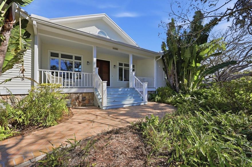 rivate Siesta Key Tropical Estate. Picture yourself living and entertaining friends and family at your Key West-style home, wrapped around a sparkling saltwater pool with a guest residence and studio apartment- all nestled in lush native landscaping on the world-renowned barrier island of Siesta Key. The main house welcomes you with a large covered front porch and double wooden plantation doors. Enter a huge sun-filled and vaulted living room with Caribbean Rosewood floors, with a view through French doors to the terrace, an open pool deck, and a wooded lot. Off the corners of the living room are three large private en suite bedrooms. The airy owner’s suite features a private library- a cozy spot to enjoy the private deck, pool, and view beyond. The kitchen is well-appointed with stainless-steel KitchenAid appliances, cherry cabinetry, and a Blue Macauba quartz island, complemented by designer touches. The kitchen opens onto the terrace and a spacious dining and family room with a fireplace. A large (27x22) Guest Suite/Bonus Room with a Full Bath is located above the 2-car garage. Tucked under the oaks is a stone patio leading into a Studio with a Full Bath. Gardens and raised garden beds are ready for you to grow your favorite foods and flowers. A private well provides irrigation. The grounds have plenty of room to run and play outdoors and can easily accommodate building expansion or additional amenities.