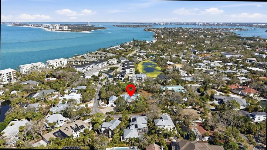 rivate Siesta Key Tropical Estate. Picture yourself living and entertaining friends and family at your Key West-style home, wrapped around a sparkling saltwater pool with a guest residence and studio apartment- all nestled in lush native landscaping on the world-renowned barrier island of Siesta Key. The main house welcomes you with a large covered front porch and double wooden plantation doors. Enter a huge sun-filled and vaulted living room with Caribbean Rosewood floors, with a view through French doors to the terrace, an open pool deck, and a wooded lot. Off the corners of the living room are three large private en suite bedrooms. The airy owner’s suite features a private library- a cozy spot to enjoy the private deck, pool, and view beyond. The kitchen is well-appointed with stainless-steel KitchenAid appliances, cherry cabinetry, and a Blue Macauba quartz island, complemented by designer touches. The kitchen opens onto the terrace and a spacious dining and family room with a fireplace. A large (27x22) Guest Suite/Bonus Room with a Full Bath is located above the 2-car garage. Tucked under the oaks is a stone patio leading into a Studio with a Full Bath. Gardens and raised garden beds are ready for you to grow your favorite foods and flowers. A private well provides irrigation. The grounds have plenty of room to run and play outdoors and can easily accommodate building expansion or additional amenities.