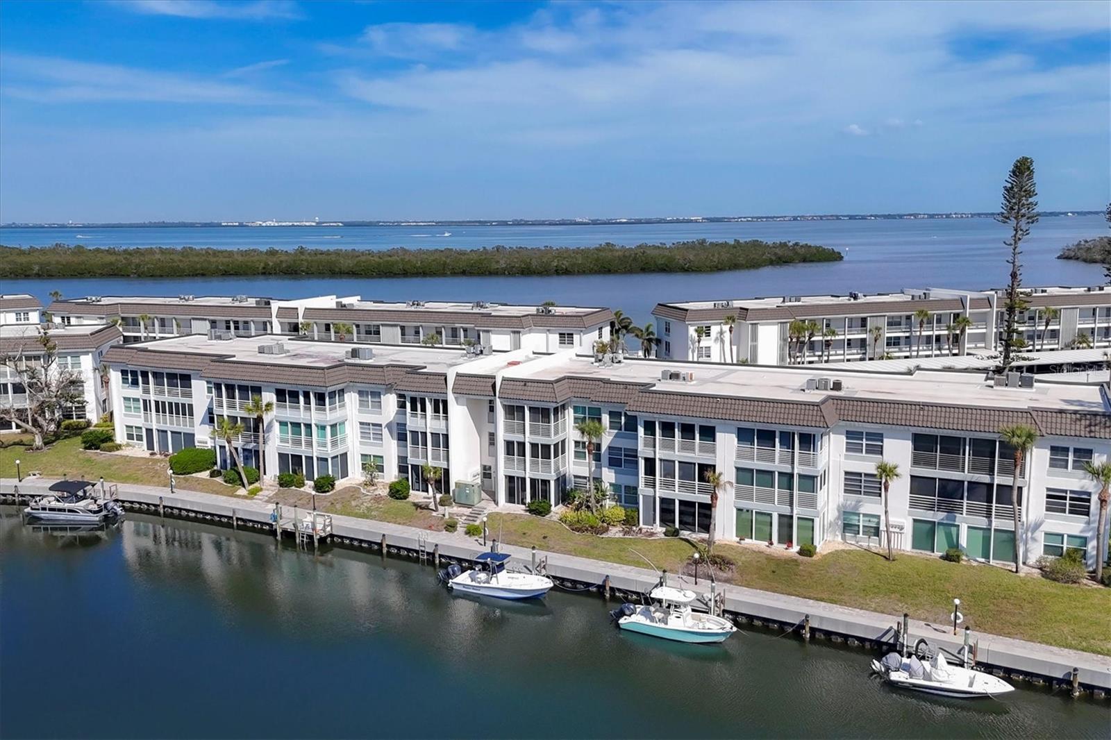 Elegantly Updated Waterfront Residence – A Perfect Retreat! Perched on the third floor, this beautifully updated waterfront one-bedroom condo offers an exceptional open floor plan that seamlessly blends comfort and sophistication. Whether you seek a luxurious seasonal retreat, an income-generating property, or a year-round residence, this home delivers the ideal setting. Complete with a covered, assigned parking space, it offers both convenience and privacy. The condo is thoughtfully designed maximizing the living space, featuring a stacked washer and dryer conveniently located in the hallway closet, alongside ample storage options, including additional space in the lanai and a dedicated storage room on the third floor. Every detail has been carefully considered to create a relaxed yet refined living experience. Step outside to a fabulous, gated beach resort that offers a wealth of amenities, perfect for both relaxation and recreation. Indulge in one of the four heated pools, stay fit in the exercise room, or enjoy friendly competition on the pickleball and tennis courts. For outdoor enthusiasts, a putting green, kayak launch, and boat slips further enhance the active coastal lifestyle. Just across the street, the gated deeded beach access (located at 4415 Gulf of Mexico Drive) awaits, offering a private resident parking lot. Here, you’ll find a cabana with restrooms, showers, changing rooms, and secure storage, providing the perfect place to unwind after a day at the beach or to enjoy a sunset in absolute peace and privacy. This residence combines the best of both worlds: a peaceful retreat with assigned carport parking, gated access, and proximity to the unparalleled dining, cultural, and recreational experiences of both Longboat Key and Sarasota. This exceptional property offers everything you could desire. Live the lifestyle you deserve schedule your private showing today. The New roof replacement is in process. The assessment has been paid.