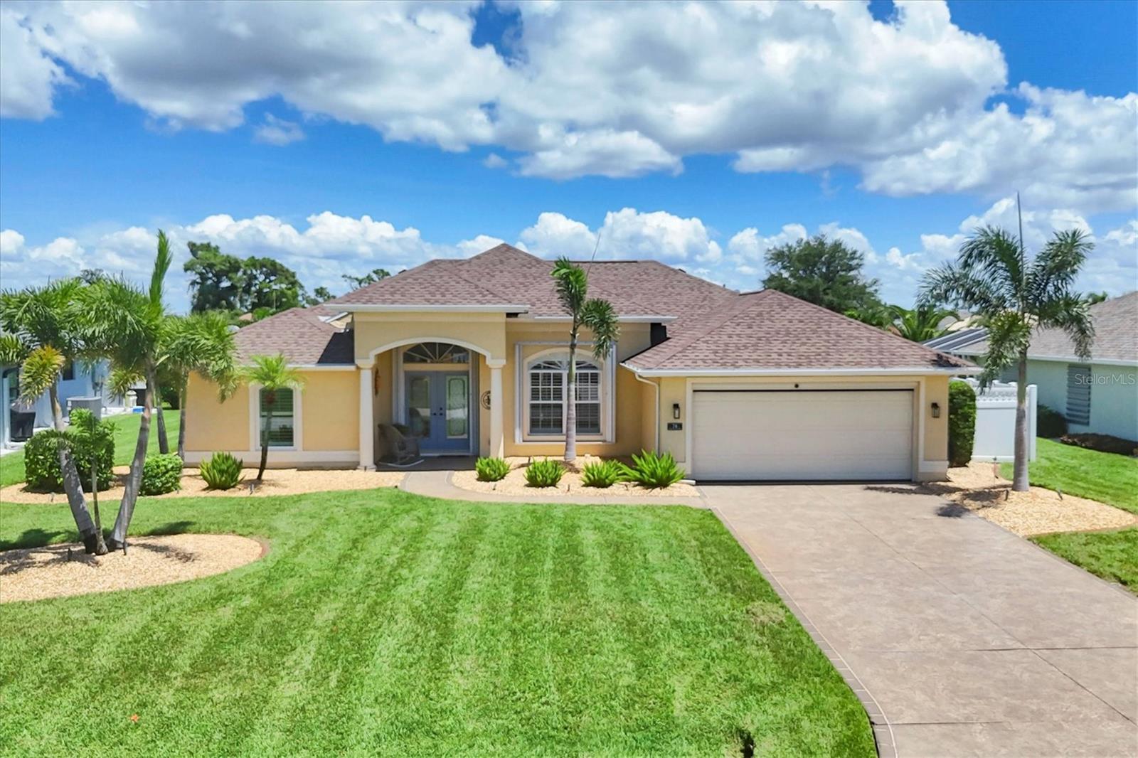 Welcome to Your Private Florida Oasis- Turning Heads: Very Impressive: Step through the double glass French doors, and your gaze sweeps across the elegant living room to a serene scene—cascading waterfalls spilling into a heated pool, all set against the backdrop of a sparkling freshwater canal teeming with fish. From the very first moment, you will feel it—this is a home of pride, care, and beauty. Designed for both comfort and sophistication, it offers a split floor plan with spacious rooms, 12-foot ceilings, and graceful double-tray accents. The family room, with its wide sliding doors, seamlessly blends indoor and outdoor living, inviting you to the lanai and pool area for year-round relaxation. The open kitchen, bright and welcoming, is a chef’s delight with its center island and solid-surface countertops—perfect for casual mornings or gourmet evenings. A versatile third bedroom doubles as a finely crafted home office, complete with built-ins and a custom Murphy bed for overnight guests. The master suite is a retreat in itself, featuring a tray ceiling, two walk-in closets, and private slider access to the lanai and pool. Outdoors, lush tropical landscaping, winding garden paths, and full hurricane protection surround you with peace of mind and natural beauty. Located just minutes from pristine beaches, championship golf, boating, marinas, fine dining, shopping, medical care, and more—you’ll have the best of Florida living right at your doorstep. By day, it’s a tranquil resort-style haven. By night, it glows with breathtaking lighting for a true five-star experience. See the rest, then come and experience the best. Welcome to this distinctive home, designed to cater to the needs of a high-quality lifestyle.