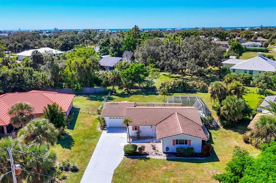 Welcome to Sorrento South, a deed-restricted community west of Tamiami Trail in Nokomis. This two-bedroom, two-and-a-half-bath, one-car garage pool home offers 1,545 square feet of interior living space on a 15,500-square-foot oversized and fenced lot. Offered as-is, this residence presents a substantial opportunity to transform and personalize the interior and exterior to reflect your vision of a dream home. An open floor plan includes a spacious great room that flows into a screened lanai with a heated pool under a soaring enclosure. The kitchen features stainless steel appliances, a breakfast bar, and a seamless connection to the living and dining areas. Wide views of the expansive backyard from the covered and screened lanai enhance the outdoor living experience. Residents enjoy low annual homeowners association dues of $300 and access to community amenities, including the nearby Bayshore Executive Golf Club and marina. Private boat slip rentals may be available. The community permits golf cart and bicycle access to Nokomis Beach, as well as proximity to waterfront dining, boutique shopping, and cultural attractions on Venice Island, Siesta Key, and downtown Sarasota. Set within an established, upscale neighborhood, the location offers convenient access to Interstate 75 and major regional airports. With year-round sunset views and proximity to beaches, golf and coastal recreation, schedule your showing now.
