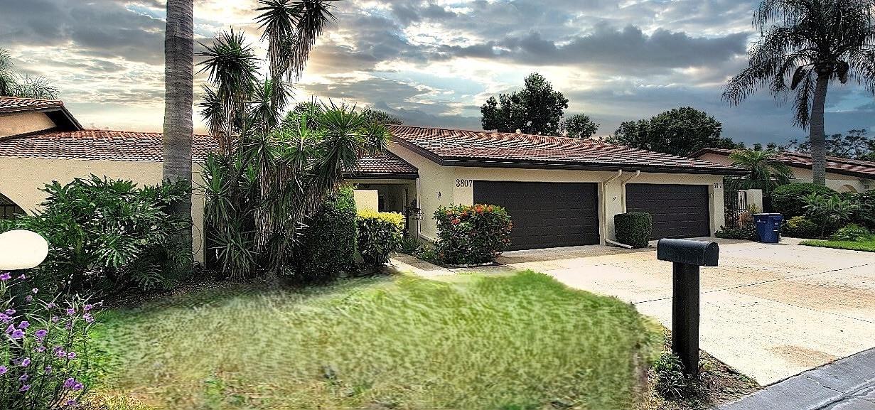 Charming villa in Village Plaza in the heart of Sarasota! This lovely ground-floor villa boasts vaulted living room ceiling, fresh paint, updated lighting, handsome expresso cabinetry, and neutral beige counter tops in the kitchen with stainless steel appliances, The updated neutral tile flows throughout the space. Relax in the sunroom overlooking a private green garden area with no rear neighbors. Additional features include a bright family room, a cozy screened patio, a dining area, and an indoor laundry room. The primary bedroom is very spacious with walls of closets in the dressing area and bathroom. Notable features/upgrades include custom shutters, raised-panel interior doors, custom closet shelving in primary closets and laundry room, newer water heater, an insulated garage door, and most popcorn ceilings replaced with flat ceilings. This has a slightly oversized 2-car garage as well. Village Plaza now features a mostly updated clubhouse! There is a large clubroom with kitchen, a billiards room, sauna, exercise room, shuffleboard, large library, heated swimming pool plus a grill area and tables for community gatherings. Village Plaza is close to all that Sarasota has to offer including I-75 (3.5 miles), Sarasota Memorial Hospital (3.5 miles), downtown Sarasota (4.5 miles), and Siesta Key (3.5 miles). This villa is only a short distance to Walgreen's, Publix, Starbuck's, restaurants, shopping, banks, and gym! Welcome to Village Plaza. An over 55 Community with many, many activities and clubs, including cards, book club, planned dinners and social events, and cruises!