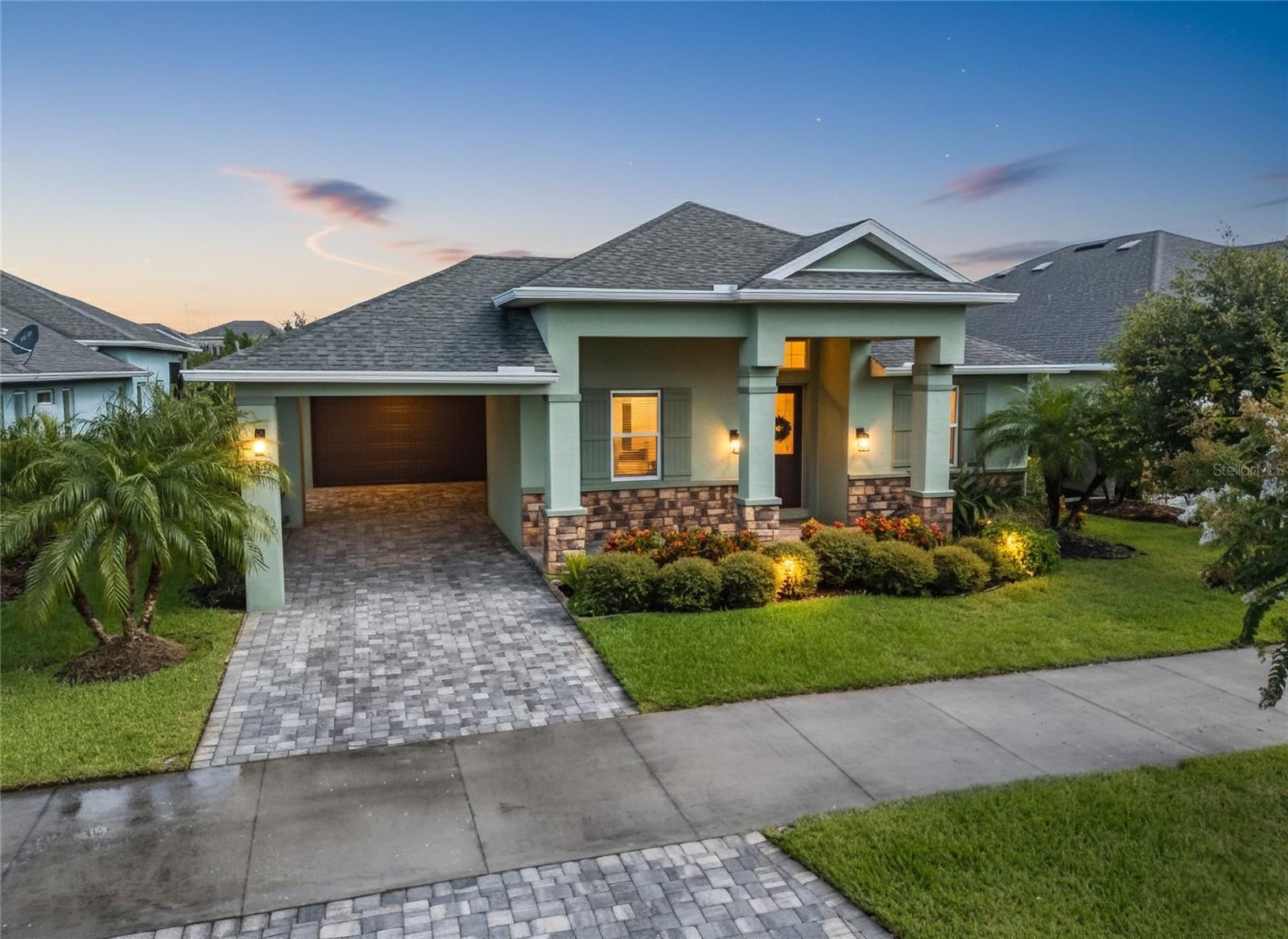 One or more photo(s) has been virtually staged. Experience refined Florida living in this stunning 3-bedroom, 2.5-bath pool home with private office, perfectly positioned on a premium waterfront lot offering expansive long-lake views. Designed with both elegance and functionality in mind, this meticulously maintained residence boasts tile flooring throughout, soaring ceilings, and thoughtfully placed sun tunnels—three in total—filling the home with natural light. The gourmet kitchen is a chef’s dream, featuring a KitchenAid gas range powered by a 500-gallon propane tank, pot filler, double oven, built-in microwave, tile backsplash, granite countertops, recessed lighting, soft-close drawers, and generous 42-inch cabinetry. The adjacent inside laundry room is equally well-appointed with a deep sink and custom cabinetry for storage. Retreat to the spacious primary suite, which offers a large walk-in closet and a luxurious bath complete with dual vanities, a walk-in shower with dual shower heads, and upscale finishes. The guest bath includes a beautifully tiled walk-in shower. Step outside to your private oasis, where a resort-style pool with cascading waterfall awaits. The fenced yard is ideal for pets or entertaining, and the home is already plumbed for an outdoor kitchen, complete with TV cable hookup—perfect for game days or al fresco dining. A paver driveway, remote-controlled shades, ceiling fans, and security cameras add comfort, convenience, and peace of mind. Additional highlights include a 2019 Carrier A/C system and a Tesla full-home solar system, to be paid off in full at closing—making this home future-ready.