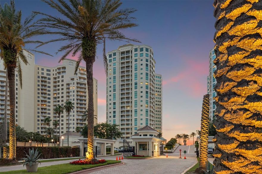 The Grande on Sand Key sets the standard for refined Gulf front living, where concierge service, security, and resort style amenities create one of Clearwater Beach’s most distinguished coastal addresses. Beautifully remodeled with a sophisticated warm modern design, this exceptional fourth floor residence captures sweeping direct and angled views of the beach and Gulf, offering what many consider the ideal elevation for enjoying both the shoreline and spectacular sunsets.  Spanning approximately 2,521 square feet, this three-bedroom, three-bathroom residence was thoughtfully redesigned with clean architectural lines, luxurious custom cabinetry, quartz countertops, modern lighting, stainless steel appliances, and a striking glass tile backsplash. Travertine flooring flows throughout the living spaces, enhancing the home’s calm and sophisticated coastal aesthetic.  The open floor plan creates seamless living and entertaining spaces centered around a spacious Gulf front balcony designed for sunset dinners, cocktails with friends, and year round enjoyment of the coastal breezes. Expansive walls of glass fill the home with natural light while framing extraordinary water views from the main living areas and primary suite.  Privately positioned, the primary retreat offers sweeping beach and Gulf views, a large walk in closet plus two additional closets for exceptional storage, and a spa inspired bathroom complete with dual vanities, a cosmetics station, and a deep soaking tub.  One of the residence’s most valuable and uncommon features is the inclusion of a rare private under building one-car garage in addition to a second reserved parking space, providing a level of convenience, security, and storage capability seldom found in Gulf front condominium living.  Life at The Grande delivers the feel of a private coastal resort, with concierge service, security, beachfront pools and spa, tennis courts, fitness center, cabanas, and direct beach access all contributing to an effortless luxury lifestyle.  Sophisticated yet comfortable, polished yet inviting, this is beachfront living designed for those who appreciate exceptional quality, privacy, and unforgettable Gulf views.