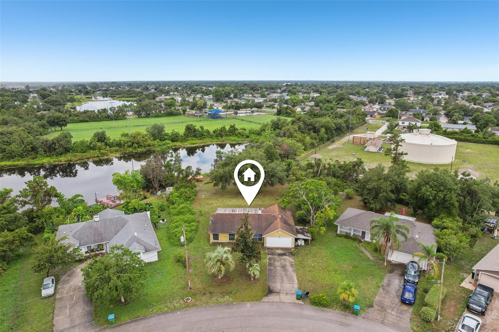 Opportunity is knocking in Deltona Lakes! This 3-bedroom, 2-bath block home with a dedicated office is priced to sell, making it the perfect canvas for investors, flippers, or savvy buyers looking to build instant equity. Situated on an oversized .44-acre lot in Flood Zone X (no flood insurance required), this property features stunning lake views, a private fishing dock, and no HOA restrictions—offering rare freedom and flexibility. The home’s layout includes a walk-in kitchen pantry, stainless steel appliances, and a sliding glass door off the kitchen area leading to a massive screened lanai with panoramic lake views—perfect for entertaining or quiet mornings with coffee. The primary suite offers its own private bathroom and walk-in closet, and the 2-car garage provides ample space for parking and storage. An additional covered carport area is ideal for a golf cart, boat, or extra storage needs—a major bonus in a lakeside community. Location-wise, it doesn’t get better—just 25 miles from the beaches of New Smyrna and Daytona, and less than 45 minutes to Disney, Universal Studios, and the heart of Orlando. Enjoy easy access to I-4, nearby shopping, dining, and top-rated schools.
Whether you’re planning to flip, rent, or renovate for yourself, this lakefront gem is loaded with potential. Priced to move. Sold as-is. Bring your vision and make it yours.