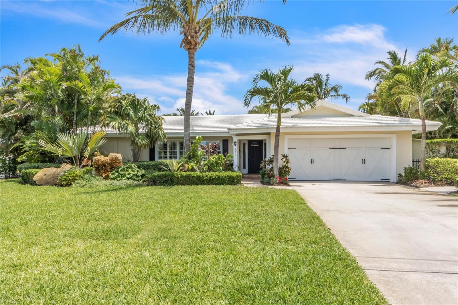 Florida charm hits hard with this canal front Holmes Beach ranch-style property. Vaulted ceilings with tongue and groove accents set the tone for island living. Multiple living areas to create your prefect lounging spaces when you're not out enjoying the AMI waterways. Three bedrooms, 2 bathrooms, with the kitchen centered in the heart of the home, this split floor-plan creates a layout that will be enjoyed by all. Step outside to your heated pool and beautiful lanai oasis with privacy curated in the lush landscaping. Take a swim in the heated pool, fish off the dock, or go for a boat ride - no bridges and easy, direct access to the Gulf of Mexico and Tampa Bay! Equipped with a boat lift, new seawall in 2021, and a 2 car garage this home is the perfect palate for your personal touch!