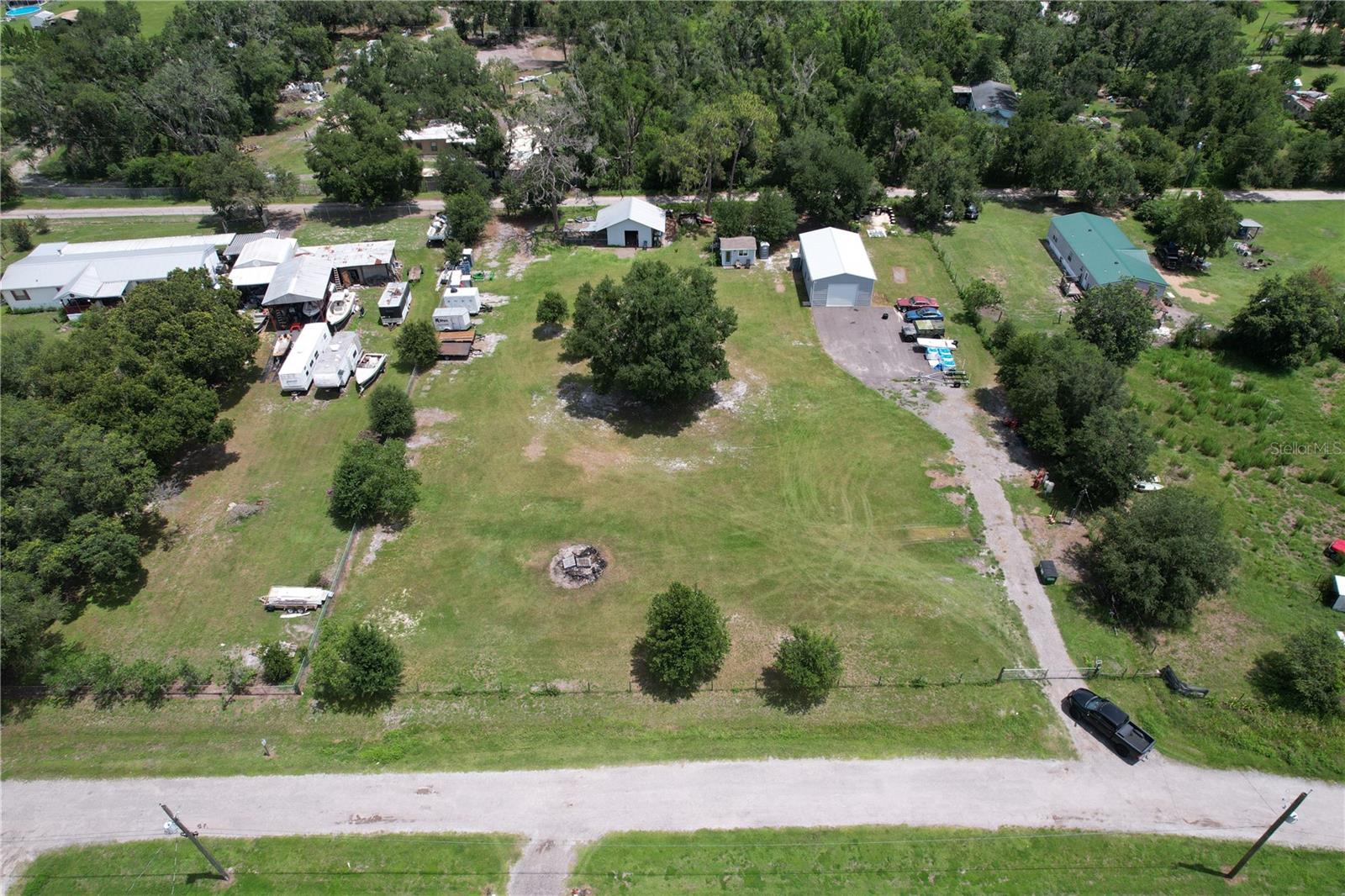 NICE PROPERTY IN THE COUNTRY! COMPLETELY FENCED WITH GATE, BEAUTIFUL OAK TREES. PROPERTY HAS ELECTRIC & CABLE ALREADY CONNECTED, WELL & 20x40x14 METAL BUILDING ON CONCRETE SLAB WITH 200 AMP SERVICE WITH 12' ROLL UP DOOR. NICE CHICKEN COOP & SMALL OFFICE WITH A/C ALSO ON THE PROPERTY. ASPHALT DRIVE ON TO THE PROPERTY WITH CONCRETE SLAB IN FRONT OF METAL BUILDING. THE ONLY THING MISSING IS YOU! PROPERTY IS READY FOR YOUR DREAM HOME TO BE BUILT OR A MANUFACTURED HOME. PERFECT SET UP FOR YOUR TOYS OR FARM ANIMALS. THERE IS NO SEPTIC ON PROPERTY. MINUTES FROM SHOPPING OR RESTURANTS