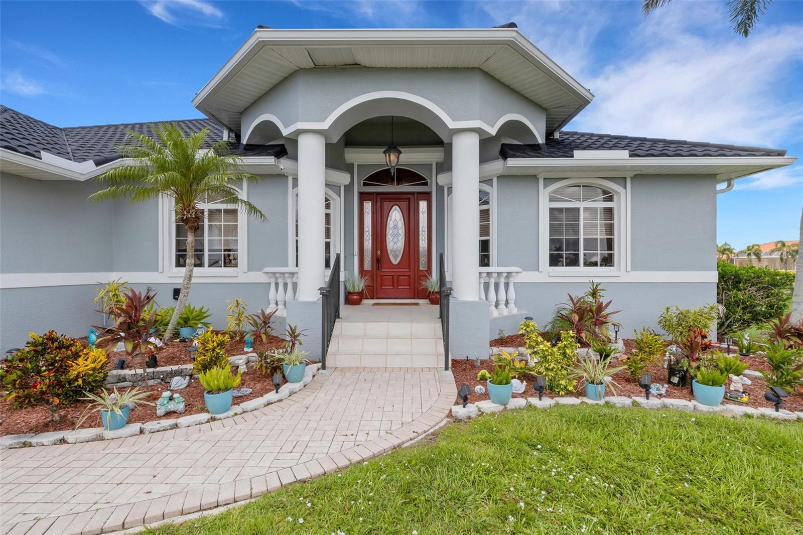 Welcome to this custom-built masterpiece, perfectly situated on a sailboat-access saltwater canal in the highly sought-after Punta Gorda Isles. Only 15 minutes to Charlotte Harbor through Beckley Pass. Boasting 3 spacious bedrooms, 2.5 baths, and 2,302 square feet of thoughtfully designed living space, and a large heated pool, this home offers the ideal blend of comfort, elegance, and coastal living. NEW metal roof in 2023. NEWLY painted inside and out. NEW 10,000 lb boat lift motor. NEW pool heater and pump in 2023. NEW lanai with panoramic screens in 2023. Hurricane shutters are fully automatic. Whole house vacuum.
Inside, you'll be captivated by the bright and airy open floor plan, highlighted by soaring ceilings, expansive windows, and abundant natural light. The great room design seamlessly connects to a formal dining area and a chef’s dream kitchen—complete with granite countertops, a breakfast bar, recipe desk, closet pantry, and ample counter space to satisfy even the most discerning culinary enthusiast.
The split-bedroom layout provides privacy and convenience. Retreat to the luxurious primary suite, featuring tray ceilings, private access to the lanai, dual walk-in closets, and an elegant ensuite bath with dual vanities, a water closet, soaking tub, and a separate walk-in shower. The generously sized guest bedrooms also have walk-in closets, high ceilings, and ceiling fans for added comfort.
Step outside to your private waterfront oasis. The expansive screened lanai, newly built in 2023 with panoramic screens, features over 1,120 square feet of outdoor living space adorned with brick pavers. Enjoy year-round entertaining with a 335-square-foot covered area that includes an outdoor kitchen, built-in grill, outdoor shower, pool storage, and convenient access to the pool bath. The heated pool, resurfaced in 2024, is the perfect spot to relax and unwind while taking in the tranquil canal views.
Boaters will love the extended 45-foot concrete dock equipped with a brand-new 10,000 lb boat lift—just steps from your back door. Additional highlights include a two-car garage, energy-efficient AC with a heat recovery system, a state-of-the-art security system, and electric roll-down hurricane shutters for peace of mind.
This exceptional property is a true Florida dream—offering luxury, lifestyle, and direct access to Charlotte Harbor and beyond. Don't miss your opportunity to own this waterfront gem!
