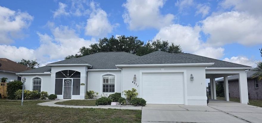 Welcome Home, this 3-bedroom 2 bath home is situated on an oversized lot with a stunning lake view, property gives you room to entertain in the oversized kitchen and enjoy the outdoors in your own pool. The fenced area is great for kids or pets. The house only has a one car garage, but the exceptional oversized carport is designed for both convenience and versatility. Easily drive in and keep your vehicle protected or back in your boat, tailor, small RV etc. Widened driveway is great for your multiple vehicles and easy access. Did I mention city water? That's right city water, indoor laundry room, hurricane shutters and so much more!