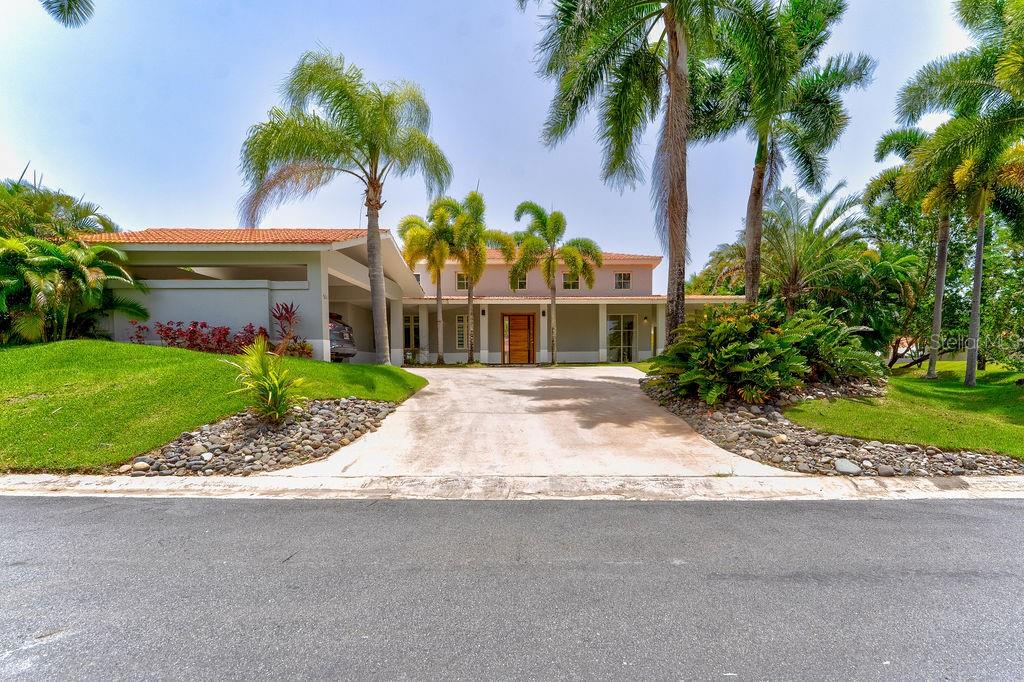 One or more photo(s) has been virtually staged. Tucked away in the lush paradise of Sabanera de Dorado, this beautifully remodeled corner residence brings together tropical elegance and modern comfort. Spanning 5,300 sq ft of total construction—with 3,715 sq ft of stylish interior living—it features four spacious bedrooms, three full bathrooms, and a guest powder room. Soaring ceilings and a bright, open layout invite island breezes into the living area, while the gourmet kitchen shines with sleek countertops and top-of-the-line appliances, perfect for culinary adventures.
Set on a generous 1,045 sq meter lot, the home embraces the outdoors with a private pool surrounded by swaying palms, vibrant landscaping, a breezy gazebo with a fully equipped outdoor kitchen, and a convenient exterior bathroom—ideal for entertaining under the Caribbean sun. Every appliance and electrical fixture is brand new, offering peace of mind and modern efficiency.
Enjoy the exclusive lifestyle Sabanera Dorado is known for, with 24/7 security, scenic nature trails, resort-style pools, tennis courts, and a fully equipped fitness center—all in a serene, tropical setting.