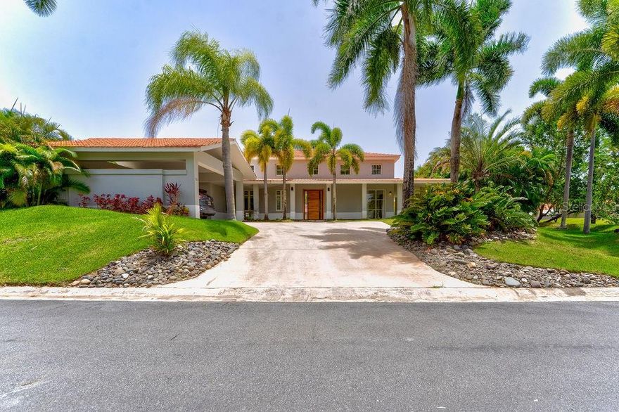 One or more photo(s) has been virtually staged. Tucked away in the lush paradise of Sabanera de Dorado, this beautifully remodeled corner residence brings together tropical elegance and modern comfort. Spanning 5,300 sq ft of total construction—with 3,715 sq ft of stylish interior living—it features four spacious bedrooms, three full bathrooms, and a guest powder room. Soaring ceilings and a bright, open layout invite island breezes into the living area, while the gourmet kitchen shines with sleek countertops and top-of-the-line appliances, perfect for culinary adventures.

Set on a generous 1,045 sq meter lot, the home embraces the outdoors with a private pool surrounded by swaying palms, vibrant landscaping, a breezy gazebo with a fully equipped outdoor kitchen, and a convenient exterior bathroom—ideal for entertaining under the Caribbean sun. Every appliance and electrical fixture is brand new, offering peace of mind and modern efficiency.

Enjoy the exclusive lifestyle Sabanera Dorado is known for, with 24/7 security, scenic nature trails, resort-style pools, tennis courts, and a fully equipped fitness center—all in a serene, tropical setting.