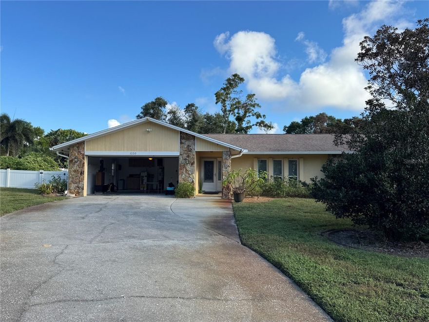 Beautiful 3/2 with 2 car garage home with. Fenced yard on a cul-de-sac road.  Enter from the front door into the large formal living area with formal dinging combination with tile floors.  This home has a friendly feeling that goes throughout!  Past the formal living area and in the middle of the home is a nicely tucked kitchen with granite countertops and all the appliances including dishwasher, oven, New Microwave and Refrigerator.  Plenty of natural lighting and recessed ceiling with ceiling fan.  Kitchen is centrally located between formal dining along with eat-in kitchen and also the family room in the back with a stone surrounded fireplace.   Two bedrooms conveniently off of the family room separated by a full bathroom.  The Owners suite is on the other side of the home and is large enough for any size bed along with side tables and dressers.  The master bath has double sinks and walk in tiled shower.  This home has a large screened patio out back with plastic windows that can be closed and all looking out on two sides to the large fenced in yard that has lots of tropical plants.  All this and close to shopping, restaurants and entertainment.  This home won’t last long so call now!