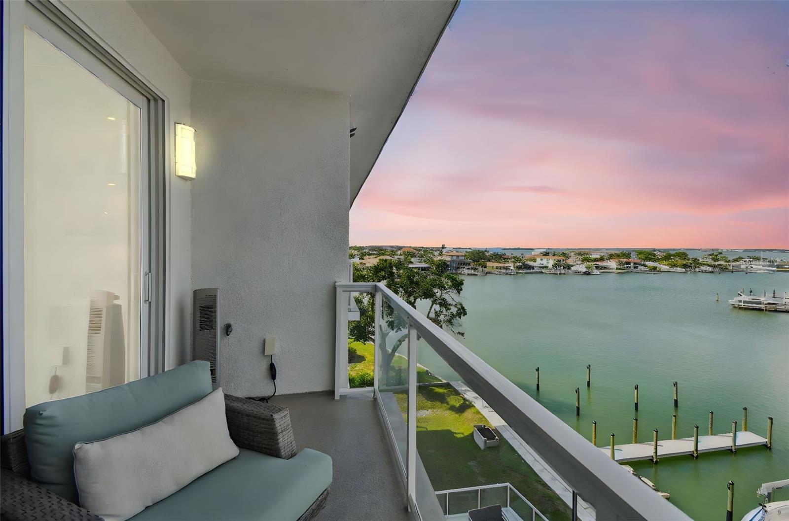 MOVE IN READY! Welcome to luxury waterfront living at its finest! This stunning newly constructed build offers the perfect blend of modern beach living. When you enter through the front door you will be amazed by the high ceilings and open floor plan. This premium unit is being offered turnkey with high end furnishings included. This top floor unit features 3 spacious bedrooms and 2 full bathrooms. The kitchen is a culinary dream with complete change out of all cabinets and appliances. Bosch appliances with extended warranties, quartz countertops, glass backsplash and pull-out custom cabinet drawers. The custom Built-in Wine Bar with lit Cabinets and 2 independent wine coolers with divided temperature zones are perfect for entertaining guests. Enter the living room and you’ll notice the custom built in fireplace, shelving, lights and cabinets, wall mounted Samsung TV and Soundbar built into entertainment wall. Step out onto your private glass balcony with new high-end epoxy finishing to patio deck. Inside, every detail has been custom upgraded by the seller with care and style. The owner’s suite is a true retreat with windows overlooking the water and motorized window treatments, decorative ceiling fan with light, Samsung wall mounted TV and soundbar, Custom California Closets, and a separate shoe closet. The en suite bathroom includes dual vanities with backlit mirrors above sinks, decorative Serena and Lilly wallpaper, Custom Cabinets added, Kohler sinks and Commode. The two secondary bedrooms share a guest bathroom. The first bedroom is currently set up as an office with Custom built in desk/dresser and corner upper cabinets with quartz finished desktop and a custom-built queen murphy bed, providing comfort and convenience. The second bedroom has decorative Serena and Lilly wallpaper and linens, Samsung wall mounted TV and soundbar, Hunter lighted ceiling fan. The Laundry Room has custom cabinets throughout with pullout drawers, removed water heater and replaced with top-of-the-line Tankless Water Heater, Electrolux Washer and Dryer with lift cabinet drawers and extended warranties. Additional upgrades include Plantation Shutters in guest bedrooms, upgraded light fixtures, tile, and Sherwin Williams paint throughout unit. The resort style amenities include fitness and yoga center, large outdoor pool, hot tub, and an amenity terrace that overlooks the bay. There are 46 total units in the Azure Condominium. Boat slips may become available through other owners. The location cannot be beat. Enjoy easy access to world renowned Clearwater Beach, shopping, dining, and marina. Come and explore coastal elegance on Clearwater Beach!