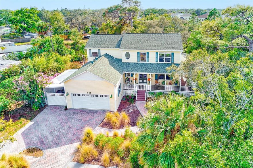Welcome to a truly enchanting Tarpon Springs retreat—rich with character, warmth, and an unmistakable sense of charm. Set on .29 acres of whimsical, lush landscaping, this Victorian-inspired home features 3 bedrooms, 2.5 bathrooms, and 2,222 sq ft of beautifully maintained living space surrounded by mature fruit trees including passion fruit, avocado, banana, star fruit, and moringa. A small pond adds to the magical, garden-like ambiance of the property.
A handsome paver driveway and walkway lead you to the gracious wrap-around porch and into a home where personality and comfort shine. The main level features real hardwood flooring in the primary living spaces, with luxury vinyl plank in the cozy family room—complete with a gas fireplace fueled by the property’s buried propane tank. The propane system also powers the gas range, the water heater, and even home heating, offering efficient energy usage rarely found in Florida homes.
The kitchen is ideal for those who love to cook, offering abundant cabinetry, generous workspace, and a large walk-in pantry. Head upstairs to the spacious primary suite, which includes two oversized walk-in closets and a beautiful ensuite featuring a jetted soaking tub and a separate dual-showerhead stall. Thoughtful touches continue throughout the home, including an upstairs laundry chute that leads directly into the first-floor laundry room.
Perhaps most importantly, the home’s resilience sets it apart: it remained completely dry and suffered zero damage during the devastating 2024 storms, a rare comfort in this coastal region.
For buyers seeking more space for gardening, hobbies, outdoor recreation, or expanded living, an adjoining .19-acre parcel is available for purchase separately. The seller currently enjoys the additional land for planting and open green space—an opportunity future owners can continue in their own unique way.
Located just minutes from Fred Howard Park, local beaches, the historic Tarpon Springs Sponge Docks, downtown dining, shopping, and charming local attractions, this property blends natural beauty, character, and peace of mind in a truly special way.