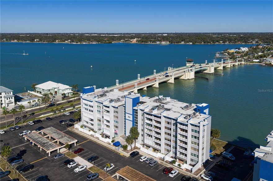 TOP-FLOOR WATERFRONT CONDOMINIUM WITH SUNSET VIEWS in Treasure Island! This beautifully updated two-bedroom, two-bath condominium is being sold fully furnished and move-in ready, making it a Florida beach retreat or full-time residence. Enjoy abundant natural light throughout, wood-look tile flooring and a west-facing private balcony, ideal for relaxing and taking in stunning Gulf Coast sunsets. This completely renovated condominium features a new kitchen and baths, fresh interior paint, hurricane shutters and hurricane windows with automatic shades. Elegant, coffered ceilings with crown molding (no popcorn ceilings) enhance the open and airy layout. The chef-inspired kitchen offers modern cabinetry, quartz countertops and new stainless-steel appliances. The adjacent dining area flows into an open bar and entertaining space with a wine and beverage refrigerator, ideal for hosting guests. Additional upgrades include a Bosch full-size front-load washer and dryer, wireless-controlled Lennox HVAC system with a seven-year warranty (2022), assigned parking, private storage room and community bike storage. The monthly maintenance fee includes internet, cable, water, sewer, trash, exterior maintenance, common areas and insurance. Residents enjoy direct access to the Treasure Bay Golf & Tennis Complex with tennis courts, pickleball courts, playground, basketball court, kayak launch, boardwalk, fitness stations, picnic areas and scenic recreational trails. Just one mile from Treasure Island Beach and minutes from John's Pass Village, shopping, dining, boating and water sports. This is an exceptional opportunity to own a waterfront condominium in Treasure Island, ideal as a primary residence, vacation home or investment property. Schedule your private showing today and experience Florida waterfront living at its finest. ALL ASSESSMENTS PAID - FULLY FUNDED!