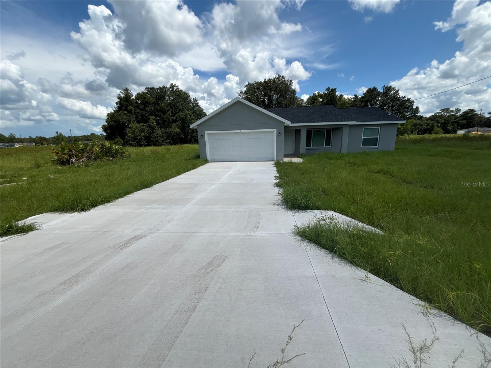 Gorgeous, brand new 3 bedroom 2 full baths 2 car garage home situated in Ocklawaha! It's conveniently close to the villages, yet offers the best of country living. You'll be the very first to enjoy this stunning home, with its captivating colors and designs. The flooring boasts a beautiful combination of light and dark gray luxury planking, perfectly complemented by white Shaker cabinets, granite countertops and stainless steel appliances. Glass top stove, Dishwasher, Over the stove Microwave, and side by side water and Ice in the door refrigerator. The house is set back from the road, providing a spacious front yard and a nice front porch where you can unwind in comfortable chairs and table with your morning cup of coffee. As for the backyard, it's absolutely perfect with plenty of space to entertain guests while playing badminton, croquet, or chipping golf balls. You could even set up a swing for the little ones, or bring the fire pit it would be perfect for those delightful evenings of entertaining guests.The home has septic and well so no water bill saves you hundreds of dollars every year! The home is very energry efficient! Rest assured, this home will not disappoint. Be the first to see it and make it yours!