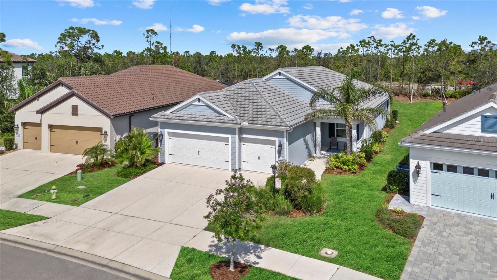 Step into this meticulously maintained, feels-like-new 3-bedroom plus den, 2.5-bath home with a spacious 3-CAR GARAGE, nestled in the award-winning, amenity-rich Grand Palm community. This stunning home boasts high-end finishes including 8-foot doors, 5-in baseboards, HURRICANE IMPACT WINDOWS, upgraded porcelain wood plank tile, quartz countertops throughout, stainless steel appliances, and a gas range for the chef at heart. The kitchen features a large pantry, soft-close cabinets, under-cabinet lighting, and a custom backsplash, seamlessly opening to the spacious great room and dining area, perfect for entertaining. Enjoy tranquil evenings on the oversized, screened-in lanai, prepped for an outdoor kitchen, with views of the private backyard—large enough to add your own pool! The primary suite offers a serene retreat with dual walk-in closets, a walk-in shower with upgraded tile, and a double vanity with quartz countertops. Throughout the home, you'll find volume ceilings, recessed lighting, ceiling fans, and HURRICANE IMPACT WINDOWS, providing both luxury and peace of mind. A transfer switch for a whole-house generator and a reverse osmosis water system add even more convenience to this move-in-ready gem. Grand Palm is a premier gated community offering a lifestyle like no other. With 3 resort-style pools (including one with a waterslide), 2 hot tubs, pickleball and tennis courts, a basketball court, walking and biking trails, dog parks, a splash pad, and multiple playgrounds, there’s always something to do. Residents also enjoy 2 clubhouses, a fitness center, a pavilion, and a full-time activities coordinator to keep the fun going year-round. Located just 15 minutes from the beach and near the new Wellen Park and Braves Spring Training Stadium, you’ll have access to shopping, dining, and entertainment. Why wait for new construction when you can own this better-than-new home today? Don’t miss out on this perfect opportunity to embrace the Florida lifestyle!