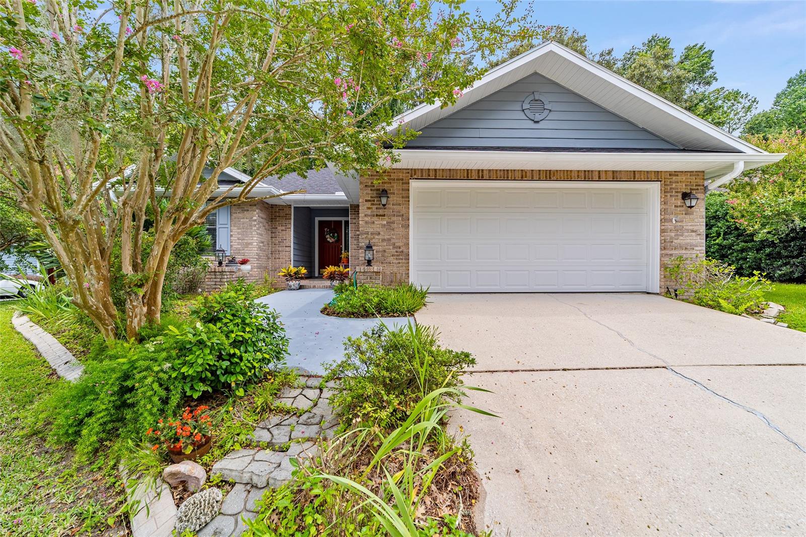 Between the rolling greens of Turkey Creek and the lush forest of the San Felasco Hammock Preserve, in a quiet corner where nature and comfort converge, this delightful two-bedroom, two-bath home offers an unexpected retreat from the everyday. Enjoy life on the fairway with access to Turkey Creek Golf Course, an 18-hole, par-72 championship layout designed by Ward Northrup, featuring rolling hills, mature shade trees, and a highly ranked practice facility just minutes from your door. A dramatic vaulted ceiling graces the expansive living room, filling the space with natural light and amplifying its sense of openness. A striking wall of built-in shelving effortlessly marries form and function, creating a perfect focal point that invites both serenity and organization. The seamless pass-through from the living room to the kitchen enhances the flow, encouraging connection throughout the home. The kitchen itself is a charming and functional space, thoughtfully designed for both culinary enthusiasts and those who love to entertain. Light spills in through oversized windows that frame the lush greenery outside, adding a refreshing vibrancy to the space. French doors from the hallway and an inviting breakfast nook make this a perfect spot for both intimate meals and lively gatherings. High-end finishes, including elegant countertops, stainless steel appliances, and warm wood cabinetry, make the kitchen as pleasing to the eye as it is to work in. Beyond the kitchen, the petite sunroom offers a peaceful vantage point of the immaculately kept backyard, where a paver patio stretches out under the canopy of trees. The area, both charming and practical, harmonizes effortlessly with the natural surroundings, creating an ideal space for quiet contemplation or casual outdoor living. The soothing presence of nature continues just beyond the fence, where a wooded view of the San Felasco Hammock Preserve State Park adds a layer of tranquility to the retreat, and frequent encounters with deer and exotic birds. Each of the bedrooms are generously sized and well-laid out, with abundant natural light illuminating the spaces. High ceilings further enhance the feeling of openness, while offering a peaceful, calming atmosphere that invites rest and quiet. With a 2-car attached garage, bonus room, and a lush front yard complete with charming plantings along the front walk, this home is as inviting from the outside as it is from within. A place that has been cherished, maintained inside and out (including a new roof installed in late 2022, and recent additions like a paneled garage door, gas water heater, smoke alarms, and energy-efficient dishwasher) and thoughtfully designed to evoke a sense of calm. This property offers more than just a home—it offers a sanctuary.