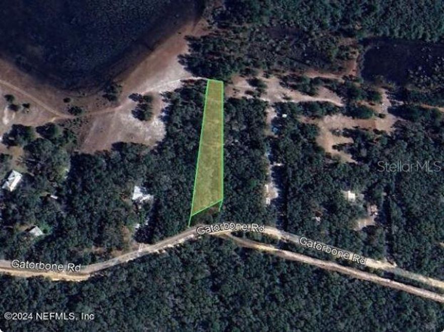 Vacant residential lot located at 7033 Gatorbone Rd in Keystone Heights, offering a great opportunity to build or invest in a peaceful, rural setting in Clay County. Zoned AR (Agricultural-Residential) allowing for site-built or manufactured homes (buyer to verify). Enjoy quiet surroundings with natural Florida landscape and no HOA restrictions. Electric nearby; well and septic required. Dirt road access. Ideal for a future homesite or long-term hold. Cash purchase only. Buyer pays all closing costs.