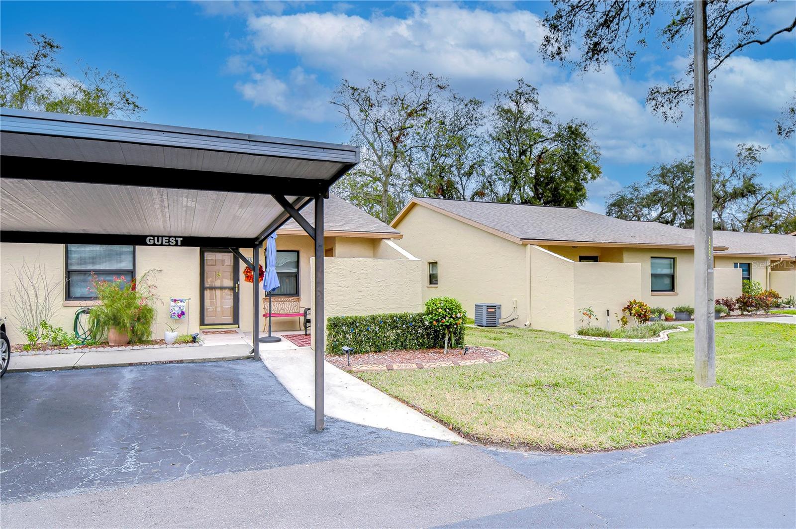 Welcome home!  This charming updated 2-bedroom, 2-bathroom end-unit condo located in the highly desirable Driftwood community, one of Zephyrhills’ most sought-after 55+ gated neighborhoods. This beautifully maintained home showcases modern upgrades throughout and offers true maintenance-free living—perfect for those looking to relax and enjoy life!  Step inside and you’ll immediately notice the luxury flooring flowing through the main living areas, complemented by ceramic tile in the kitchen and bathrooms for a refined finish. The kitchen comes complete with stainless steel appliances including a double oven, and updated fixtures—a chef’s delight with space for a cozy dinette. The open-concept dining and living area creates a seamless flow, ideal for entertaining family and friends. Both bedrooms are generously sized, easily accommodating large furnishings.  The primary suite includes a walk-in closet and an updated private bathroom with modern fixtures. A bright den just off of the living room offers flexible living space—perfect for a home office, craft room, or cozy TV lounge. The indoor laundry closet provides extra convenience, without taking up extra space or having to go outside to do laundry. This home offers peace of mind knowing the low monthly condo fee of $345 covers water, sewer, trash, lawn care, exterior maintenance, building insurance, roof replacement, and access to all community amenities.  Driftwood residents enjoy an active lifestyle with access to a clubhouse, pool, shuffleboard courts, social events, and a car wash area all within a beautifully maintained gated setting. Located just minutes from medical facilities, the hospital, grocery stores, restaurants, and local conveniences, this community offers both comfort and convenience. Pride of ownership truly shines in this move-in-ready home! Don’t miss your opportunity—schedule your private showing today. The brown part of Driftwood is a pet-free, deed-restricted 55+ community. Cash or conventional financing only.