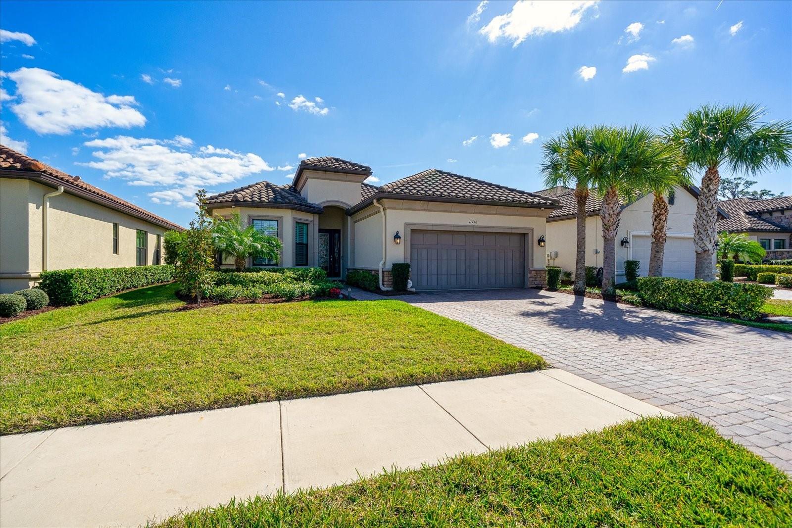This is a stunning 2018-built expanded Lazio Model built by Taylor Morrison located in Esplanade at Starkey Ranch. The house is situated on a spacious lot with no rear neighbors, ensuring ample privacy. The home features 2,429 sq. ft. of living space, 3 bedrooms, 3 full baths, a flex space, and a tandem garage, making it a well-appointed and spacious living space. Upon entering the foyer, you'll notice the 10-foot ceilings, tray ceilings, crown molding throughout the house, and plantation shutters on all windows. The entry foyer, flex space, and dining area feature wainscoting accents, while the great room has beautiful built-ins. The primary bedroom is extended, with a bay window, tray ceiling with crown molding, and an enlarged closet with a floor-to-ceiling custom closet system. The second bedroom has an ensuite and an enlarged walk-in closet with built-ins. The great room and dining area are spacious and completely open to the kitchen, which is an entertainer's dream. The kitchen is beautifully upgraded with an oversized island with double-sided cabinets, a breakfast bar, quartz countertops, extended cabinetry with crown molding, stainless steel appliances, gas range, microwave, wine fridge, pendant lighting, tile backsplash, and an extended eat-in area. The laundry room has plenty of storage cabinets, quartz counters, and a utility sink. The lanai is oversized and comes with remote-controlled hurricane shades, an outdoor kitchen with granite counters, a built-in grill, a vented hood, a sink, and extra storage. The home also features a tandem garage with ceiling storage shelves, an epoxy floor, a house generator, a tankless hot water heater, a water softener, an alarm system, an A/C system with humidity control, natural gas, landscape lighting, rain gutters, brick paved driveway, and sidewalk. This home is move-in ready and loaded with upgrades! Esplanade is a maintenance-free community located within Starkey Ranch. Amenities include a resort-style pool, dog park, fire pit, formal events lawn, and sports courts. A beautifully appointed resort amenity center with approximately 6,000 square feet features a fitness center, catering kitchen, billiard/card room, club/ craft room, and a common room. An on-site Lifestyle Manager can interact
with residents and coordinate special activities, parties, and events.