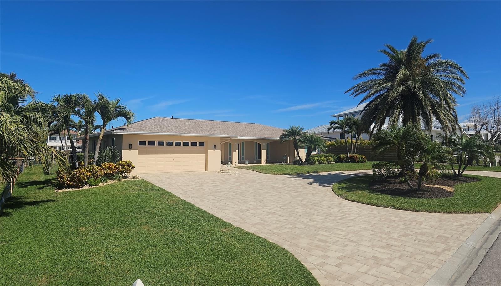 This house had no flooding after major hurricanes of 2024 due to its high elevation and hurricane resistant doors and windows.  Assumable loan available. Coveted lifestyle and location in Emerald Harbor on one of the widest canals on Longboat Key with direct access to Sarasota Bay with no bridges. Move in ready and fully furnished. New roof 2024, new heat pump and spa 2023 and outdoor pool/lanai lighting. 50 foot dock and 10,000 lb boatlift with 100 feet of seawalled waterfront. Dolphin and manatees are rugularly seen in canals. Meticulously maintained and beautifully landscaped. A spacious open floor plan with 3 bedrooms, 2 full baths and 1 half bath. There is a gorgeous pool and spa ready for immediate enjoyment. The split bedroom floor plan features sliding glass doors in the master suite, living room and dining room and kitchen opening into the screen enclosed lanai and pool.  Renovated kitchen -quartz countertops cabinets and new appliances, new bathrooms, travertine flooring, recessed lighting and freshly painted interior. Seawall, lift and dock were installed in 2017, pool and front pavers completed in 2018. Emerald Harbor is a quaint and desirable lifestyle. It is only a 5 minute walk to beach. The HOA includes a deeded beach access path. Everything in the house conveys except some select art decor. Aerial views were taken prior to new next door construction.