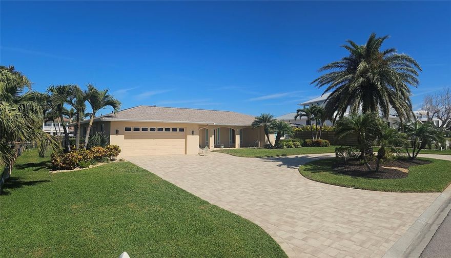 This house had no flooding after major hurricanes of 2024 due to its high elevation and hurricane resistant doors and windows.  Assumable loan available. Coveted lifestyle and location in Emerald Harbor on one of the widest canals on Longboat Key with direct access to Sarasota Bay with no bridges. Move in ready and fully furnished. New roof 2024, new heat pump and spa 2023 and outdoor pool/lanai lighting.  50 foot dock and 10,000 lb boatlift with 100 feet of seawalled waterfront. Dolphin and manatees are rugularly seen in canals.  Meticulously maintained and beautifully landscaped. A spacious open floor plan with 3 bedrooms, 2 full baths and 1 half bath.  There is a gorgeous pool and spa ready for immediate enjoyment.  The split bedroom floor plan features sliding glass doors in the master suite, living room and dining room and kitchen opening into the screen enclosed lanai and pool.   Renovated kitchen -quartz countertops cabinets and new appliances, new bathrooms, travertine flooring, recessed lighting and freshly painted interior. Seawall, lift and dock were installed in 2017, pool and front pavers completed in 2018. Emerald Harbor is a quaint and desirable lifestyle. It is only a 5 minute walk to beach. The HOA includes a deeded beach access path. Everything in the house conveys except some select art decor. Aerial views were taken prior to new next door construction.