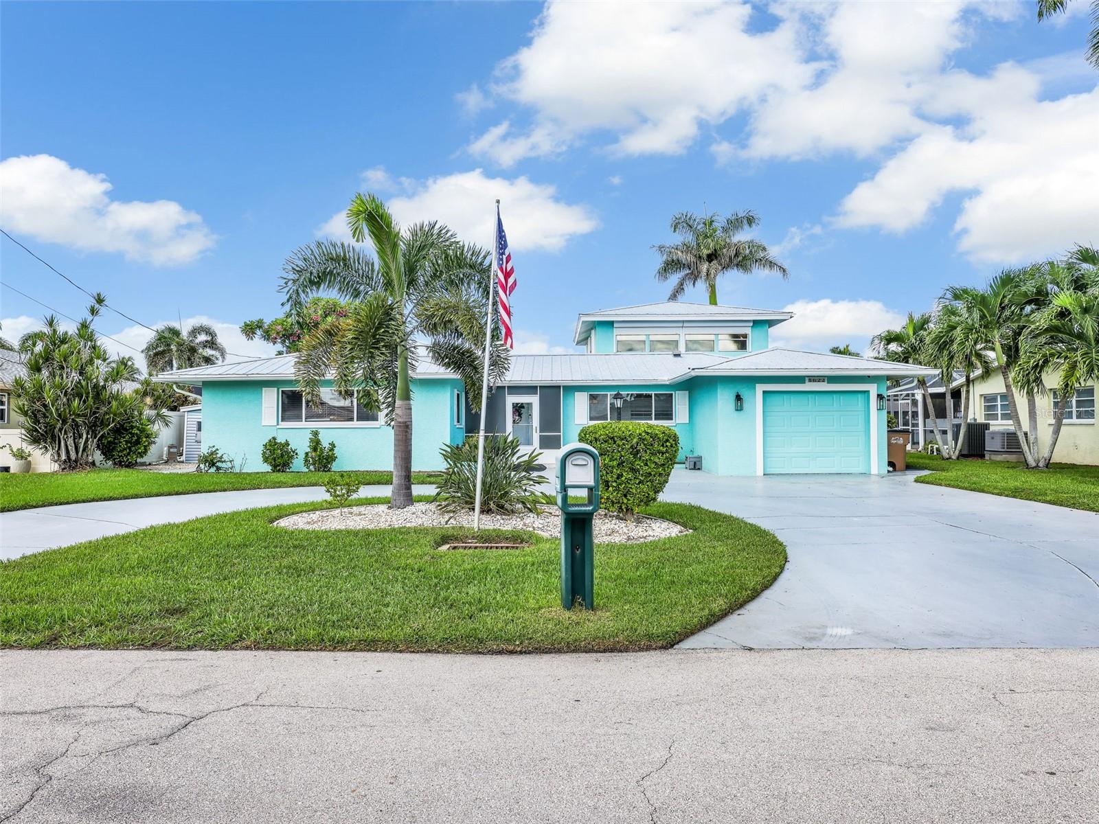 Welcome to 5622 Deauville Court, an exceptional waterfront residence in Cape Coral that offers true sailboat access with no bridges standing between you and open water. Situated just minutes from the Caloosahatchee River and the Gulf, this home combines an unbeatable boating lifestyle with extensive upgrades and modern comforts. The exterior showcases a durable metal roof with newly installed rust-proof fasteners, ensuring longevity and peace of mind. The seawall has been reinforced with a professional anchoring system designed to prevent separation, and the dock area has been updated with newer composite wood for both beauty and durability. A 15,000-pound boat lift is in place, providing the perfect setup for larger vessels. Whether heading out for a day on the water or enjoying evenings on the dock, this property is designed for boating enthusiasts who expect both convenience and security. The pool area has been thoughtfully refinished, offering a sparkling retreat set against the backdrop of wide canal views. A new pool pump and heater allow year-round enjoyment, while the extended lanai with a bar setup adds additional entertaining space. Remote-controlled roll-down shades provide ease of use and privacy. A large Florida room over looks the pool area and is equipped with its own mini split system for air conditioning and heat, making the space comfortable in every season. Inside, the home has been beautifully updated with both style and practicality in mind. The main living areas feature all-new hurricane impact windows and a slider that opens to the pool deck, creating a seamless flow between indoor and outdoor living. A fresh repaint in 2025 brightens the interiors and highlights the open layout. The kitchen has been fully remodeled with granite countertops, upgraded cabinetry, modern appliances, and plenty of space for both casual dining and entertaining. The adjacent dining and living spaces are filled with natural light, offering wide views of the water and pool area. Tile throughout the home provides durability and makes cleaning easier. The owner’s suite has been thoughtfully designed for space and functionality. The remodeled bathroom features upgraded finishes and a practical layout that complements the overall design of the home. Additional bedrooms provide flexibility for family, guests, or office space, while the upstairs loft offers a private retreat. While the second-floor windows are not hurricane-rated, accordion shutters provide storm protection and peace of mind. Throughout the home, every essential system has been updated, including all-new wiring and a new 200-amp breaker panel, ensuring modern functionality. Attention to detail can be seen in every upgrade, from the granite surfaces to the sleek finishes, all contributing to a home that is as practical as it is inviting.