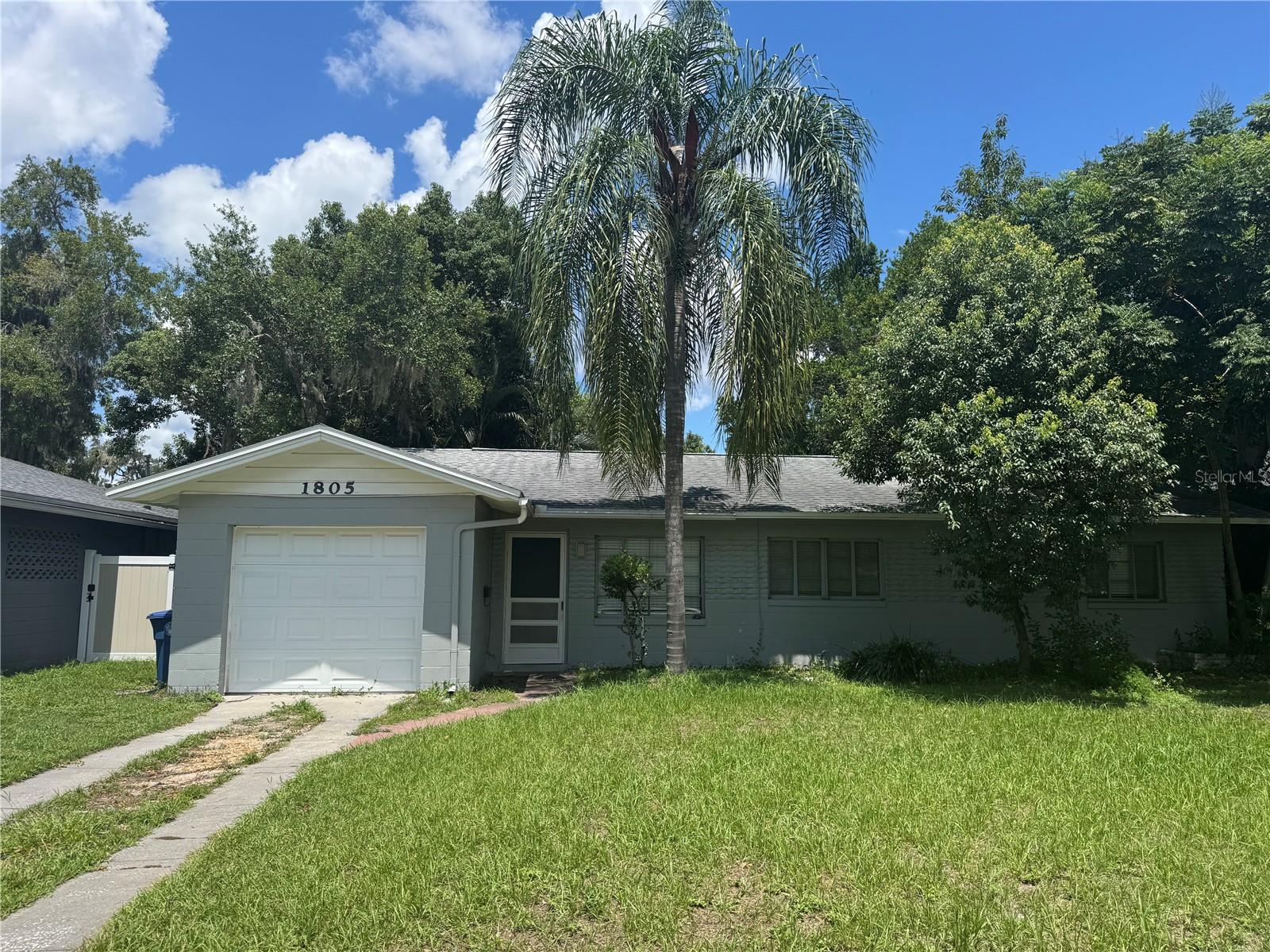 Updated 3-Bedroom, 1-Bath Winter Park single family home is now available! This charming 1951 block home has been beautifully updated with a modern kitchen and new tile flooring throughout. It features a retro-style bathroom with a tub conveniently located off the hallway near the three bedrooms. Additional highlights include a single-car garage with washer and dryer hookups, a living and dining area, and an enclosed Florida room located between the garage and living space, which overlooks the large backyard. Ideally situated near everything Winter Park has to offer. This home is just minutes from Park Avenue, Phelps Park which offers tennis and pickle-ball courts, Sprouts, Publix, dining, banks, hospitals, and more. The property offers approximately 1,422 square feet of heated living space and a total of 1,128 square feet. All information is deemed reliable, but not guaranteed.