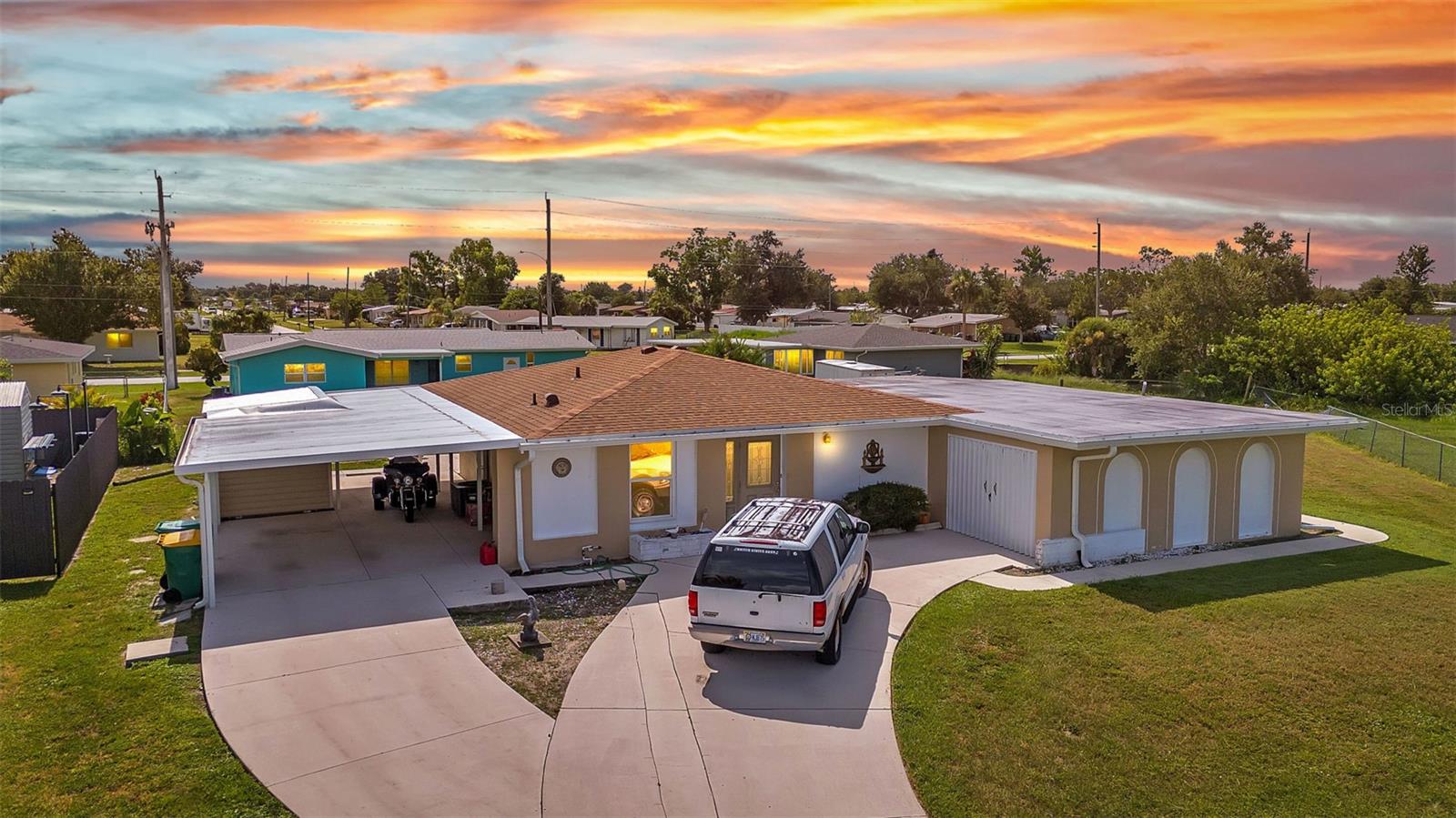 CHARMING MID-CENTURY HOME IN A QUIET CUL-DE-SAC WITH WATER VIEWS & NO FLOOD INSURANCE REQUIRED - CLOSE TO HOSPITALS, GOLFING, SHOPPING, DINING, AND MULTIPLE BOAT RAMPS!!!
Welcome to a solid concrete block ranch in the heart of Port Charlotte, offering a fantastic blend of privacy and accessibility. Situated at the end of a cul-de-sac, this 2-bedroom home sits on an oversized lot and features tranquil views of the wide canal just beyond the backyard—adding a peaceful backdrop without requiring flood insurance.
The floor plan includes over 1,300 sq ft of living space with a large screened lanai and a dedicated laundry area in the garage. Interior finishes include a mix of tile and laminate flooring, updated windows, and plenty of natural light. Whether you’re a year-round resident or a seasonal visitor, this property offers low-maintenance living in a highly desirable area.
You're just minutes from HCA Florida Fawcett Hospital and less than 5 miles to several public boat ramps including Port Charlotte Beach Park and Edgewater Boat Ramp, offering easy access to Charlotte Harbor and the Gulf beyond. Tee off at nearby golf courses like Port Charlotte Golf Club or Maple Leaf Golf & Country Club. Enjoy a variety of local dining options, retail stores, and entertainment venues within a short drive—including the Port Charlotte Town Center and waterfront dining in Punta Gorda.