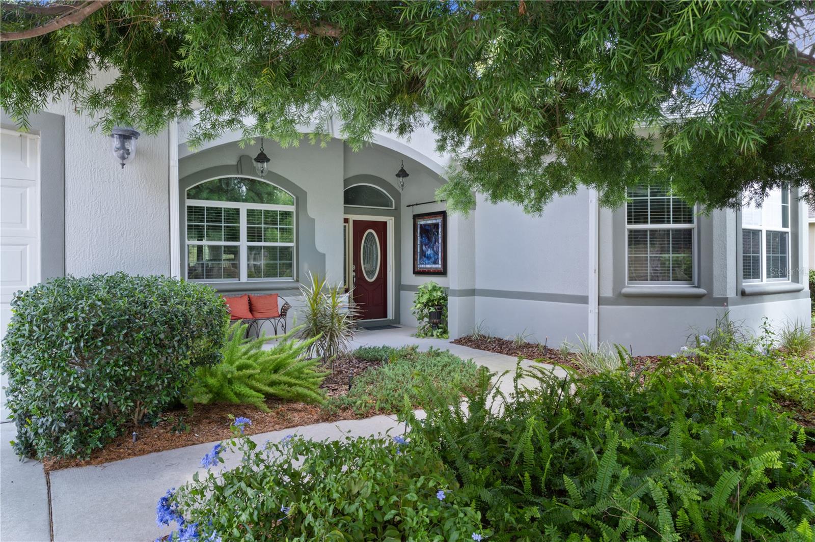 Live the life you’ve always imagined in this STUNNING Expanded WILLIAMSBURG PREMIER with over 3200 sq. ft. of beautiful living space, a Huge (844 sq. ft) 3-CAR GARAGE…and the Bond of over $25,000 HAS BEEN PAID! All about LOCATION! Situated less than 3 miles to LAKE SUMTER LANDING, this amazing home is tucked in the PREMIER Community of BRIDGEPORT of MIONA SHORES, just a short golf cart ride to numerous golf courses, recreation centers, pools, restaurants, shopping, medical and more! Truly ELEGANT, yet WELCOMING, you’ll fall in love with this meticulously maintained ONE-OWNER beauty the moment you step inside. Spacious rooms with 12’ ceilings, Engineered HARDWOOD floors, PORCELAIN Tile, CUSTOM TRIM WORK, TRAY Ceilings and CROWN Moulding barely begin to set the stage for what awaits. You have plenty of options when entertaining family or friends, whether the occasion is more casual or formal – take your pick? The Spacious Kitchen is more than just functional - offering beautiful Glass-faced and Lighted CHERRY Cabinets with Pull-out Shelves, GRANITE Counters, CUSTOM Backsplash, STAINLESS Appliances with a NATURAL GAS Range, ISLAND, Large Counter Bar, Cozy Breakfast Nook and Specialty Lighting. The VOLUME Knockdown Ceilings and OPEN CONCEPT enhance the already SPACIOUS feel of this light and bright home. Upon entering, your eyes will be drawn to the FABULOUS 578’ Climate Controlled NE-Facing SUNROOM with Tinted Glass accessible off the main living area (with Stack-back sliders) or the Primary Suite with French doors. Situated on over 1/3 acre, your own PRIVATE retreat awaits as you relax on the back Patio with Pergola surrounded by beautiful landscaping…and plenty of room to add a Pool or Expand! The spacious Primary Suite with 2 Walk-in Closets, boasts a retreat-like bath with a ROMAN Shower, GRANITE Counters with his & hers sinks, Make-up Vanity, Glass-Block Accent, Privacy commode…and the JETTED SOAKING TUB offers a perfect opportunity to unwind and treat yourself to a bit of pampering after a day enjoying your favorite activities! The SPLIT plan is ideal for the occasional guests affording privacy for all, and you’ll appreciate the extra closet space! One guest bedroom offers a Walk-in Closet and the other has 2 spacious closets, plus a large Built-in Cabinet and hide-away desk. The ROOF was REPLACED in 2024, HVAC in 2023 & TANKLESS GAS WATER HEATER in 2022. So many extras include Porcelain Tile and Engineered Hardwood Flooring (No Carpet), Lightning Rods, Whole-house Water Softener, Wireless ADT Security on every opening, Electric Garage Door Screens (on both doors), Attic Solar Fans, Solar Tube, Attic Insulation and Stairs, Lots of Shelving in garage, Freezer in garage will remain, and most appliances have been replaced (list available), +++. The BOND IS PAID! The tax line reflects property taxes only, and the CDD line reflects the combination of the annual maintenance and fire district. So….what are you waiting for? If not now, when???
