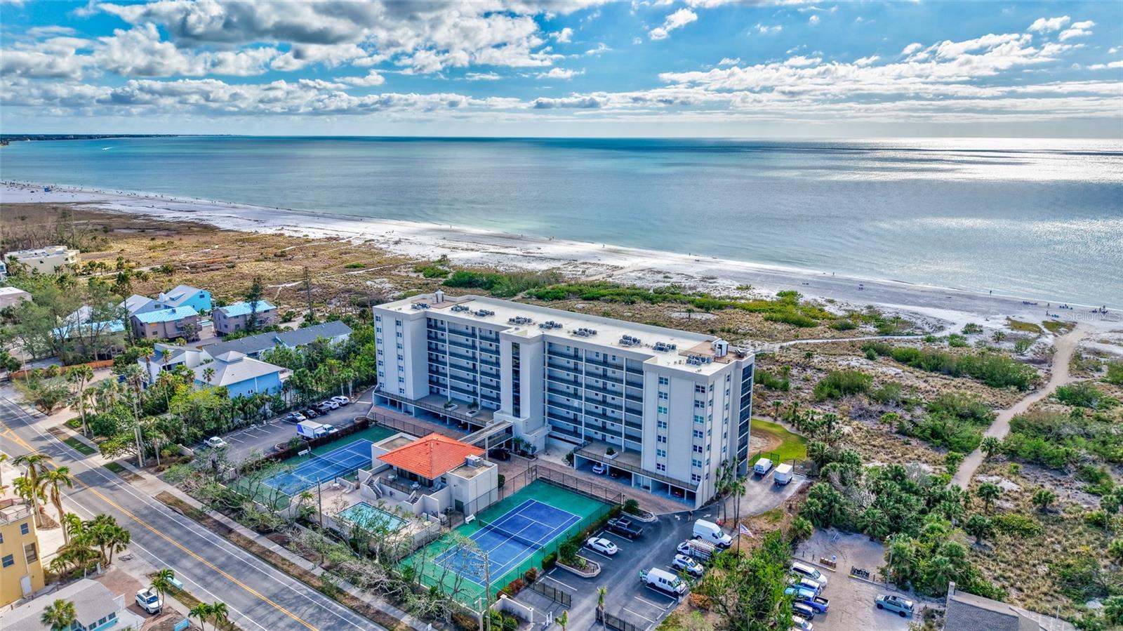Paradise Found on Siesta Key! Wake up to Gulf breezes and end each day with a sunset over the water from this direct beachfront condo at Siesta Gulf View. This 2-bedroom, 2-bath residence offers a full west-facing panorama of Siesta Beach and the Gulf from its expansive 31-foot screened and glass-enclosed balcony, accessible from the living room, kitchen, and primary suite. From here you can enjoy both the beauty of the shoreline and the natural dune vegetation that makes this second-floor perspective feel close and connected to the beach.
This floor level offers an ideal balance of easy access and elevated views: take the stairs for quick trips to the beach, pool, or parking garage, or use the elevator if preferred. No long waits, no hassle, just effortless access to every amenity.
The TURNKEY FURNISHED layout includes a light-filled open kitchen with eat-in nook (perfect as a dinette or office), two spacious walk-in closets, separate laundry room, and generous storage throughout. Recent community updates give peace of mind: milestone inspections complete, all cast iron plumbing replaced in 2024, and new clubhouse roof and landscaping nearing completion, with no special assessments.
Siesta Gulf View is a sought-after, gated, 59-unit community offering private boardwalk access to the quartz sands of Siesta Key Beach, plus resort-style amenities: a 25’x40’ heated pool, tennis and pickleball courts, fitness room, grilling areas, and clubhouse. Assigned under-building parking, ample guest parking, first-floor storage, and an on-site management office add convenience. Pet lovers will appreciate that up to two small pets are welcome.
Best of all, you’re just blocks from vibrant Siesta Key Village: restaurants, shops, and live music are a short stroll away. Whether you’re seeking a vacation retreat, investment property (one-month minimum rentals allowed up to 12 times/year), or full-time Gulf-front living, this condo delivers the ultimate island lifestyle. Don’t miss this opportunity to claim your piece of paradise.