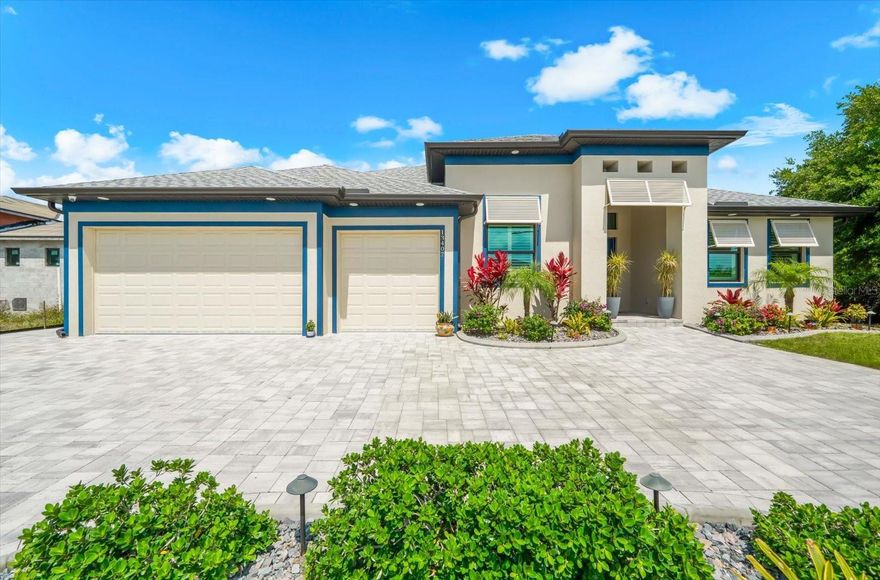 WELCOME TO YOUR WATERFRONT SHOWSTOPPER—STUNNING 4 BEDROOM, 3 BATH, plus DEN, GULF ACCESS HOME where LUXURY meets LIFESTYLE and every detail is designed to IMPRESS. Perfectly situated on a coveted Gulf-access canal, this home delivers EXCEPTIONAL BOATING OPPORTUNITIES with electric and water available at the waterline. From the moment you arrive, the elegant horseshoe driveway and lush, professionally designed landscaping create a PRIVATE OASIS, enhanced by dramatic landscape lighting and a beautiful stone walkway that wraps the home. Step through the custom glass double-door entry and into a BRIGHT, OPEN FLOORPLAN with a desirable split design, offering both functionality and privacy. Inside, you’ll find wide-plank tile flooring throughout, decorative tray ceilings, and recessed lighting that create a clean, MODERN yet inviting feel. The living space is nothing short of spectacular, highlighted by dramatic zero-corner sliding glass doors that fully pocket, and seamlessly blend INDOOR/OUTDOOR living. Plantation shutters add timeless elegance, while hurricane impact windows and doors provide peace of mind. At the heart of the home is a CHEF-INSPIRED KITCHEN that truly delivers—featuring premium GE Profile appliances, a sleek induction cooktop, double ovens, a statement designer hood, and level 4 granite countertops throughout. The massive 4x10 island is PERFECT for gatherings, while custom soft-close cabinetry, under-cabinet lighting, and a walk-in pantry with custom shelving elevate both style and function. Entertain effortlessly with a stylish indoor wet bar complete with a wine fridge—because every great home deserves a GREAT HOSTING SPACE. The expansive primary suite is your PRIVATE RETREAT, thoughtfully designed for comfort and relaxation. Enjoy a separate and private office with double-panel barn doors, an oversized custom walk-in closet with a built-in floating counter, and a SPA-INSPIRED bathroom featuring a wraparound walk-in shower with multiple shower heads, floor-to-ceiling custom tile, and a private water closet. Even the everyday essentials feel elevated with a spacious laundry room—complete with built-in countertops, a large single basin sink, and GE washer and dryer—conveniently located adjoining the primary suite. Step outside and experience RESORT-STYLE LIVING at its finest. The panoramic screened lanai and extended entertaining space set the stage for unforgettable moments, featuring a heated saltwater pool and spa, LED lighting, and a tranquil waterfall feature. An integrated audio system, roll-down shades for sun protection, and a fully equipped outdoor summer kitchen make this space truly NEXT LEVEL. This home is PACKED WITH HIGH-END UPGRADES including a Bosch tankless water heater, propane service for stove and dryer, whole house generator, high-efficiency Daikin HVAC system with 12-year warranty, HVAC surge protection, open-cell insulation, and three-zone climate control for personalized comfort. The air-conditioned, epoxy-floored garage offers even more versatility with a separate den and dedicated mini-split system—ideal for a gym, office, or FLEX SPACE— insulated garage doors for added efficiency. A canal-fed irrigation system keeps the grounds lush with ease, while a comprehensive whole-home security and camera system provides ultimate peace of mind. This is not just a home—it’s a BOLD STATEMENT of thoughtful upgrades and waterfront luxury. If you’ve been waiting for something that truly STANDS OUT… THIS IS IT.