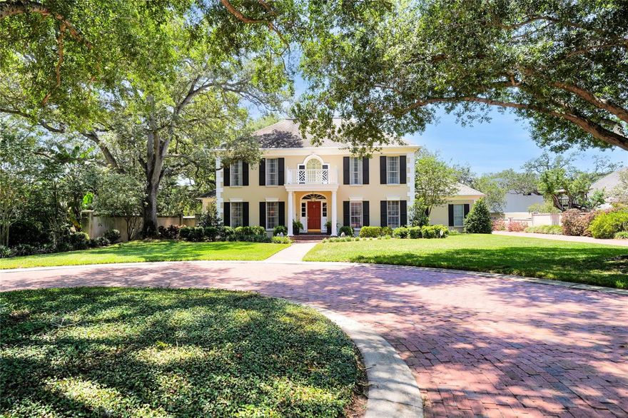 Beautiful Georgian Style Estate located on one of the most unique lots in South Tampa just off world famous Bayshore Blvd. The very private off-street lot (110’ x 215’) is accessible via a 20’x132’ private brick driveway leading to a private brick cul-de-sac. The home is a custom Traditional Georgian Center Hall plan with oversized rooms. Step inside this beautiful home which has Hatco engineered commercial grade hardwood oak flooring throughout, along with custom milled wood trim: door moldings, chair rail, baseboards, and wainscot. The downstairs Den has custom wainscot wood panels. A decorative fireplace enhances the expansive living room with a wood burning fireplace in den. The chef’s kitchen has granite countertops and stainless appliances, double convection ovens, and an eat in breakfast room adjacent to the kitchen. The first floor also features a spacious bedroom with a full ensuite bath. An expansive covered back porch with brick floor can be accessed from the den and breakfast room and provides a gorgeous view of the massive back yard with plenty of room to add a pool. Head up the beautiful staircase to find the spacious master bedroom featuring an abundance of natural light, his and hers walk in closets, master bath with marble floors, jetted tub and large marble shower. Two additional upstairs bedrooms both contain ensuites, a walk in closet in one, and a triple closet in the other. A large laundry/mud room is just off the kitchen which also provides access to the garage. The oversized garage can accommodate 2/3 cars, easily fitting a large truck and has new insulated storm proof garage door and opener with separate work area. The home features double pane insulated windows with custom wood raised panel shutters on the front rooms. The rear covered porch with brick floor and rear brick  patio with a front covered porch and brick walkway private plenty of space for outdoor activities. New  paint in all bedrooms, baths, kitchen and laundry. New: 80-gallon hybrid heat pump water heater,  Maytag washer, Bosch dishwasher, Schlage door hardware, Kohler bathroom fixtures, quartz  countertops, sinks, low flow toilets and window blinds. 3 A/C units: upstairs downstairs and first floor  bedroom. The home has a very high first floor elevation and is located in an X Flood Zone. The Sprinkler  system is on separate meter. For safety, the home contains monitored hard wired fire and alarm systems  and also Arlo smart wireless exterior security cameras. Mature landscaping shield’s view from all  surrounding houses and Charleston style concrete stucco exterior walls are around 90% of the property.  Enjoy this beautifully custom home, add on or build new as the lot would accommodate an 8000-1000sf  house. Call today for a showing of this truly unique and private South Tampa Estate.