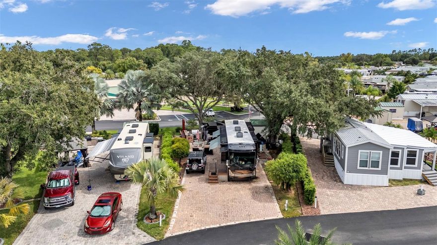 Beautiful lot in Elite Resorts at Citrus Valley! Park your RV on the extra wide and extra-long pie shaped paver pad and enjoy your own slice of Florida Living in this sought-after Clermont RV Resort. Lot 2 is a perimeter lot that conveniently backs directly up to the clubhouse and is located in a luxury portion of the resort ("The Oaks") which offers a lot of space and privacy. The 10x12 storage shed has laundry hook-ups and electric, plus the luxury outdoor grilling kitchen, gazebo and mature landscaping create an outdoor-living oasis for you and guests! The lot has full hookups, room for parking, irrigation, landscape lighting, a grass area for pets and ample paver walkways. You have much more room than you'd expect on an RV lot, so there are tons of possibilities! This top quality resort is only 12 miles from Walt Disney World and offers many amenities including 2 resort bathhouses, laundry facilities, Bingo, a Veteran's Group, variety entertainment shows and social events. The lawn is cut regularly by the association and your HIGH SPEED INTERNET, cable, sewer, water and trash pick-up are all included in your quarterly Condo dues of $756. Low maintenance living, leaves you plenty of time to enjoy local attractions. You can call this beautiful property home in the Winter, or year round... Call today to set up your showing!