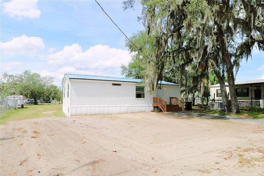 Discover affordable Florida living with this well-maintained 3-bedroom, 2-bath double wide mobile home with NO HOA and NO lot rent — you own the land! This home features a desirable split-bedroom floor plan and numerous updates throughout. The spacious primary suite offers an ensuite bathroom with convenient in-bath laundry space, and the washer and dryer are included.  Recent improvements include upgraded interior walls, luxury vinyl plank flooring, updated bathrooms, a metal roof installed in 2023, new well pump and tank within the past six months, new tie-downs and skirting within the last 1.5 years, HVAC approximately 4 years old, and a 100-gallon water heater approximately 6 years old.  Conveniently located with easy access to local dining, shopping, and outdoor recreation. Just minutes from popular Lake Pierce destinations including Cherry Pocket Steak & Seafood Shak, Bok Tower Gardens, Camp Mack River Resort, and the Lake Pierce public boat ramp. Whether you're looking for a full-time residence, seasonal getaway, or investment opportunity, this property offers comfort, convenience, and value.