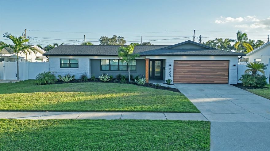 Discover this beautifully renovated home in one of St. Pete’s most desirable neighborhoods, Holiday Park. Every detail has been professionally redone for modern living, comfort, and peace of mind. The open floor plan features luxury waterproof vinyl flooring, LED lighting, and crown molding. A brand-new kitchen offers quartz countertops, shaker cabinetry, LG Smart appliances, under-cabinet lighting, a large island with seating, and a coffee bar perfect for everyday living or entertaining. The primary suite includes a walk-in closet and custom tile shower, while the other three bedrooms are spacious and bright. Both bathrooms are fully updated with modern finishes and fixtures. Built for efficiency and security, this home includes impact-rated windows and doors, a new AC system, solar panels PAID in full keeping electric bills under $100 on average. Step outside to a travertine patio, new landscaping, and a finished two-car garage with AC and storage. Just a short drive to Tyrone Mall, great restaurants, and 4 miles to the Gulf famous beaches, this home delivers modern comfort, style, and savings in a prime St. Pete location.
