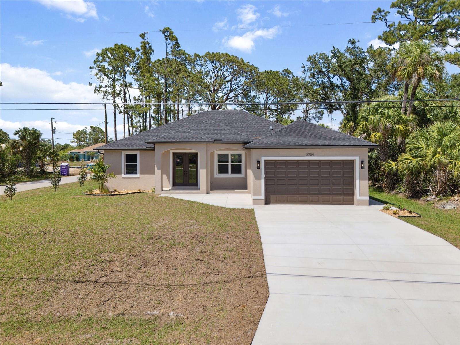 Welcome to your dream home—where luxury meets lasting craftsmanship in this beautifully built 4-bedroom, 3-bathroom residence with a 2-car garage, situated on a spacious corner lot in the heart of North Port.
Built on a solid 3-course stem wall foundation in an X flood zone, this home offers peace of mind with hurricane impact-rated windows, doors, and garage door. As you enter through the French doors, you’re greeted by an open-concept layout with tray ceilings, ceramic tile throughout, and an abundance of natural light. The heart of the home features a stunning kitchen with bold granite countertops, white shaker-style 42” cabinets, and a oversized island with storage on both sides—designed to impress and function.Granite carries through to every bathroom and even into the laundry room, showcasing attention to detail and quality. The open living space flows seamlessly to a spacious covered lanai, perfect for indoor-outdoor entertaining.
For added convenience, the third bathroom offers direct access to the lanai, making it ideal for future pool plans—something this home is already tailored for. The layout also includes spacious closets, a split-bedroom design for privacy, and modern finishes like matte black fixtures and designer lighting throughout.
Highlights Include:
• 1,813 sq ft living space | 2,813 total sq ft
• Corner lot with room for a pool
• Concrete block construction
• Impact windows, doors & garage
• Granite throughout—including laundry
• Contemporary fixtures and finishes
• Oversized lanai with pool-ready design
• Tray ceilings & split floor plan
Whether you’re a family, retiree, or professional, this move-in-ready masterpiece delivers the perfect blend of luxury, durability, and flexibility. Schedule your private tour today and experience Florida living at its finest!