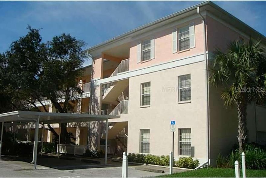 BEAUTIFUL, GATED HERITAGE OAK PARK with LAKEFRONT, OAK TREES, WALKPATHS, AMENITIES, FRIENDLY!  TURNKEY, First Floor with OPEN Floor Plan.  Park in your covered CARPORT.  Front ENTRY OPENS up the entire OPEN Floor plan!  From ENTRYWAY view the tiled KITCHEN that FLOWS into the Spacious LIVING Room with the LANAI and the Lake VIEWS.  Enter in EAT-IN Kitchen with Pantry closet, eat in area and BREAKFAST Bar.  MASTER BEDROOM with generous WALK-in Closet (8x6).  Master BATH with large Shower stall, double sinks and COMFORT height Vanity.  Off the Kitchen the Hall to BR 2 and Large Hall BATH w tub and extra cabinets.  Also the Laundry Closet holds newer FULL Size Stackable GE WASHER & DRYER.  UPDATES - ALL New Luxury Vinyl Plank flooring, MODERN Lights and Fans in the Main Room & Kitchen, Extra Cabinets to Bathrooms for more storage.  ROOF was done in 2023. AC 2022 & Water Heater 2020.  This is a Lovely ACTIVE Gated Community with quick access to shopping & restaurants.  Amenities in the park include Clubhouse, Heated Pool Library, Billiards room, fitness room, shuffleboard, bocce ball, tennis courts pickleball & walking paths around the LAKE.  FULLY FURNISHED - Just move right in and LIVE the LIFESTYLE!  (ALL information deemed reliable, however, should be VERIFIED with Association)