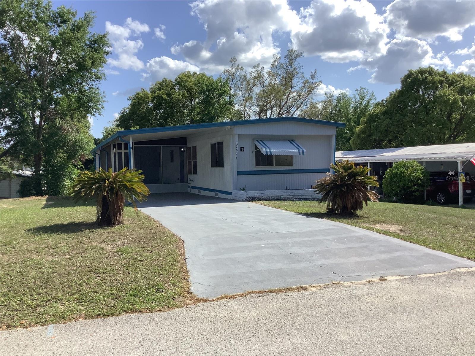 NO LOT RENT!!! County water and sewer. No Mandatory HOA fees. Must see to appreciate! Superb condition and ready for new owner. Don't let the age fool you, this owner has done all the work for you and it shows! This move in ready mobile has new 3/4" tongue and groove exterior plywood subfloors throughout entire home along with new laminate flooring and commercial grade vinyl flooring in baths and laundry areas. New bathroom fixtures and vanities, a new 50 gallon hot water heater along with a new central heat and air system that was installed April 2025. All new pvc water lines installed throughout. The kitchen has been updated with new custom cabinets, new above stove microwave and countertops. You will also notice home has been freshly painted inside and out along with freshly painted drive and carport area. Interior of the home has new trim and Wainscoting along with solid wood window casings and sills. Enjoy your morning coffee or relax in the evenings on your 12x24 screened porch with new indoor outdoor carpeting. There is also a great storage/workshop area. If you are looking for the perfect retirement or winter retreat, look no further! Located in a quiet community and awaiting your arrival and your personal touch.