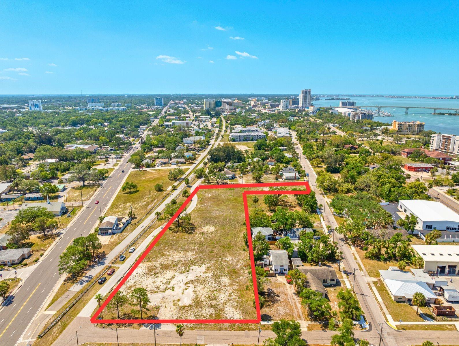 Wow, look at this property in Clearwater zoned Downtown and Commercial. This is a package listing that consists of 9 adjoined properties. Included in the list price is the subject Industrial Zoned property, along with 8 other parcels, all vacant Commercial lots. All totaling close to 2 Acres - 2 zoning classifications C - Commercial and D - Downtown - Allows for Commercial and Multi Family use - All public Utilities and Off Site Retention - Site plan permit ready to be pulled, - Good Road Frontage and Size Visibility on a corner lot, bordering the Pinellas Trail. Current plans and permits are available - Conveniently located near downtown Clearwater and Clearwater Beach. Can be combined with MLS #TB8373144 for an additional approximate 1 Acre making for approximately 3 Acres total or sold separately.