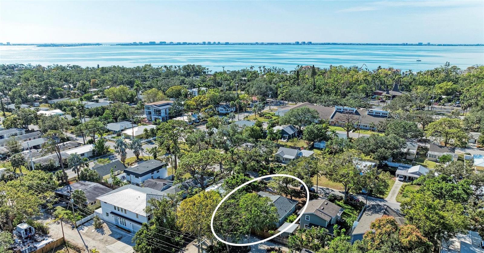 Your charming tropical oasis awaits in the desired neighborhood of Indian Beach, located west of trail just blocks from Sarasota Bay! Step into this meticulously cared-for and loved bungalow, where classic charm meets modern tranquility, just moments from downtown and sugary-sand beaches. This spacious and inviting home immediately embraces you with its warm ambiance, enhanced by beautiful hardwood floors flowing throughout, combined with modern touches and an inviting, cozy flair. Thoughtfully renovated and beautifully painted inside and out, every detail reflects pride of ownership. Enjoy unparalleled serenity and protection with hurricane windows installed on each and every window (2025), including the skylight, ensuring both abundant natural light and storm protection. A newer roof (2021) and newer a/c (2023) will add to your peace of mind. Beyond the captivating interior, discover outdoor living with a courtyard ideal for your potted plants, colorful flowers or simply a space to savor your morning coffee. Enjoy a natural element to your outdoor space, with a beautiful, fully private, spa-like outdoor shower to refresh under the stars, after a day at the beach or an invigorating start to your day! This bungalow's unbeatable location is key to a coveted lifestyle. You're just minutes from Sarasota's vibrant downtown, offering endless dining and entertainment options, a short drive from the area's pristine beaches and mere minutes to Sarasota International Airport. Don't miss the opportunity to own this Indian Beach gem- A true blend of charm, comfort, and coastal convenience!