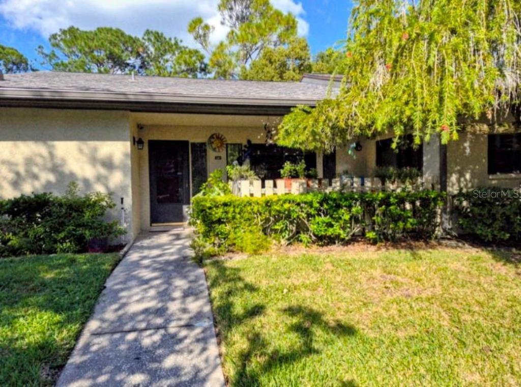 This well maintained 2 bedroom 2 bath villa in Quail Forest tucked away in the gated East Lake Woodlands Community is now available for you! The open floor plan and wet bar create a great entertaining area. Both ensuite bedrooms feature plenty of closet space and sliders that open to the finished Florida room. The Florida room overlooks a serene back yard where deer walk through. You will enjoy both front and back patios. You have your own carport with additional guest parking. $10,000 of hurricane panels for all windows and doors are included. New roof 2024. The Quail Forest Community features a beautiful pool for residents. This home is perfect for snowbirds and year round residents.
