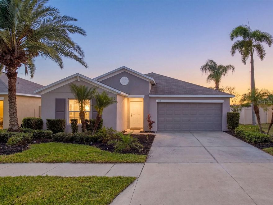USDA ELIGIBLE HOME which means ZERO DOWNPAYMENT. Just over 1,900 sq ft of living space, water view in the back, very low HOA, and low-cost solar panel lease keeps the A/C costs very low even in the summer. Totally worth it! . . . . . . . Step inside and you're immediately welcomed by soaring high ceilings and an abundance of natural light that pours through every room. The open-concept layout is both practical and elegant, featuring a split bedroom floor plan that gives the owner's suite its own private wing while keeping the other 3 bedrooms accessible for others. Decorative wall accents and designer touches throughout the interior are a nod to the home's model home origins -- details you won't find in standard builds. 
From the moment you arrive, the professionally landscaped curb appeal sets the tone: lush palm trees, manicured plantings, and a clean, polished exterior that reflects the care this home has received. As a former model home, it was built to impress, and it still does.
The heart of the home is a large, open kitchen designed for both everyday living and entertaining. With ample counter space, 36-inch raised-panel cabinetry, modern appliances including a dishwasher, and a layout that flows seamlessly into the family room, this kitchen makes gathering easy and cooking a pleasure. 
The owner's suite is a true retreat. Generous in size, it features an en-suite bathroom with a large walk-in shower, double sink vanity, a water closet for privacy, linen closet, and a walk-in closet that delivers the storage space today's buyers expect. The secondary bedrooms are well-sized and share a full bath. 
Throughout the home, you'll find tile and LVP flooring -- no carpet anywhere -- making maintenance simple and keeping the space feeling clean and modern. 
Step out back and the view will stop you in your tracks. A full 46 feet of your lot sits directly on a serene private pond. There are no rear neighbors, no road noise, no intrusions -- just water, sky, and the kind of quiet that is increasingly hard to find in a growing community. Whether you're starting your morning with coffee on the patio or watching the sun set over the water in the evening, this backyard delivers a daily experience that simply cannot be replicated in a standard subdivision lot. 
Hawk's Landing is a low-HOA community conveniently positioned near I-75, putting the best of the Tampa Bay area within easy reach. Gulf beaches, Tampa's dining and entertainment scene, top retailers, and major employers are all accessible without the congestion of living closer to the city. MacDill Air Force Base is approximately 31 miles away, and Tampa International Airport is under 30 miles.