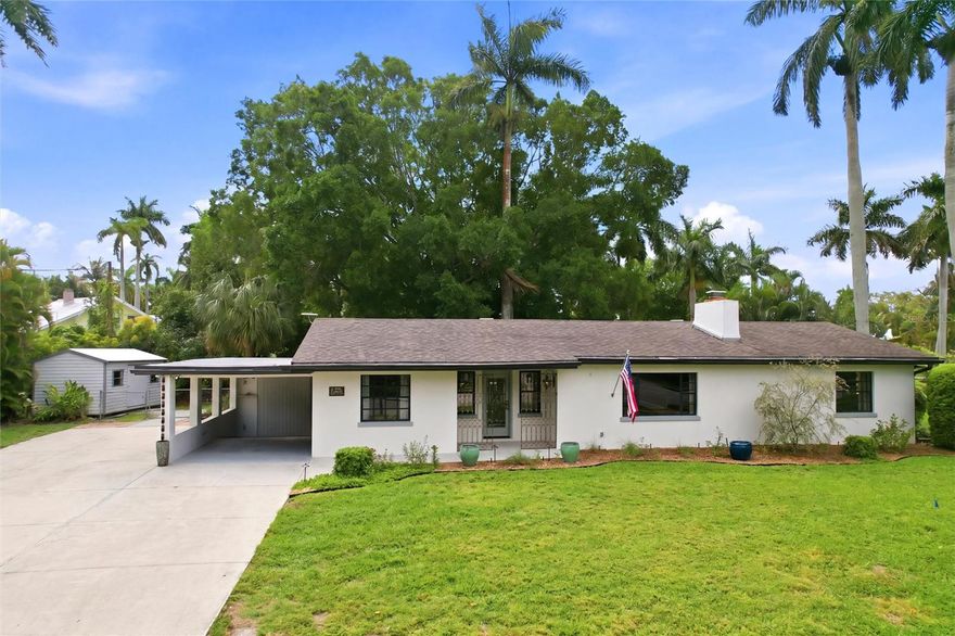 This 3-bedroom, 2-bathroom ranch-style home is set on an expansive .39-acre lot adjacent to the beautifully landscaped Triangle Park. Situated in the heart of the prestigious Dean’s Park Historic District, this charming residence captures the essence of classic Florida living. Renowned for its historic significance, picturesque streets, and enduring charm with no HOA! The fully fenced backyard provides exceptional privacy and generous outdoor space with a historic Banyan tree to provide shade in the hot summers. An attached covered carport offers convenient protection, while an additional paved area allows for ample parking—ideal for multiple vehicles or a boat. Significant improvements add peace of mind, including a whole house water filtration system, new plumbing in 2025, newer roof in 2019, and a tankless water heater 2023. The welcoming foyer opens into a spacious family room. Terrazzo flooring flows throughout the home, enhancing its clean lines and timeless appeal. Abundant natural light highlights the open, airy layout, while the central living space transitions seamlessly into the newly updated kitchen. Thoughtfully redesigned, the kitchen features an open layout to the dining/living areas. Highlights include  2023 appliances, professional-Bartazzoni gas range with a stainless vent hood, Bespoke refrigerator, new wine cooler, quartz countertops with lighting underneath for elegance and charm. An expansive peninsula offering additional prep space and casual seating. Light-finished upper cabinetry, including glass-front display cabinets, is beautifully balanced. A tile backsplash, recessed lighting, and a window over the sink complete this stylish and functional space. The living room is anchored by the refurbished original fireplace with a tiled surround set against a rich wood-paneled accent wall. The primary suite features a beautifully updated, spa-inspired bathroom. A glass-enclosed walk-in shower showcases floor-to-ceiling tile and sleek fixtures for a bright, streamlined look. A floating stone vanity with an integrated sink and contemporary hardware pairs elegantly with modern lighting. Two additional guest bedrooms are generously sized and share a vintage full bathroom that reflects the home’s timeless character. Additional interior highlights include a dedicated laundry room with utility sink. An attached utility shed adds even more convenience for tools and equipment and another detached 160-square-foot shed with electric. Step outside to a peaceful, private backyard designed for relaxation and entertaining. A spacious paver patio creates an inviting outdoor living area, ideal for gatherings or quiet evenings beneath mature trees. Lush landscaping and established greenery frame the yard, highlighted by a stunning Banyan tree that provides year-round comfort. The expansive backyard offers ample room for recreation, gardening, fruit producing mango tree all while maintaining a serene, park-like atmosphere.  This home is just minutes from the vibrant Downtown Fort Myers River District, offering easy access to dining, boutique shopping, waterfront parks, live entertainment, and community events. Fort Myers Beach, Sanibel, Captiva, and Southwest Florida International Airport are all within an easy drive. 
PLEASE ENJOY THE 3D INTERACTIVE VIRTUAL TOUR ASSOCIATED WITH THIS LISTING.