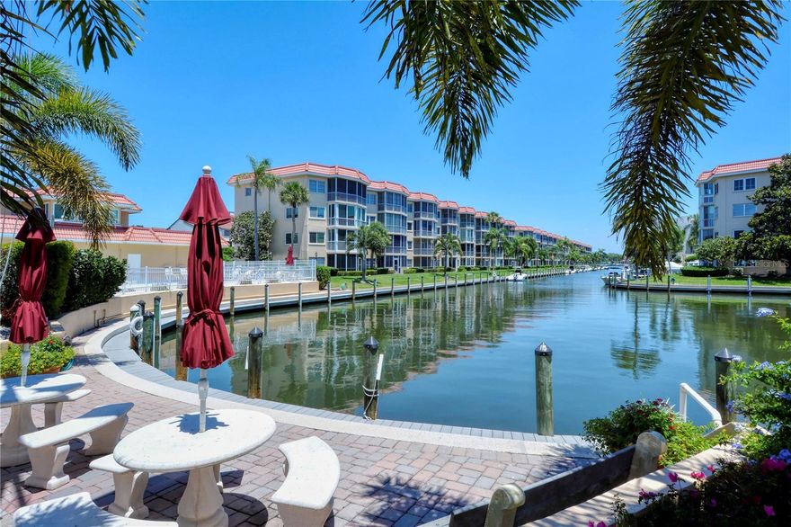 PRICED TO SELL!  LOWEST PRICE RENOVATED 2 bedroom 2 bath condo is Siesta Harbor! So many upgrades, granite counters, stainless appliances, ceramic tile, impact sliders, turnkey Furnished! Water views from the living room, main bedroom and lanai, screened in lanai, great active clubhouse, heated pool, outdoor spa, out door shower, shuffleboard, barbecue area and outdoor shower.  Private Beach access directly across the street. Siesta Harbor is located on the deepest point of the main intracoastal. Deep canal, boat slip up to 30' boat (check for availability, reasonable annual pricing.) Stunning Dock for fishing or relaxing ..... walk to all, restaurants, shops, easy on and off the key, the Trolley and scat right outside your door! One of the best parts being on the intracoastal with Beach Access! This has it all, just bring your toothbrush and be in paradise! Or rent it out, its a 30 day rental 12 times a year!!