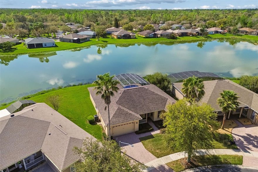 Expansive waterfront living with 112 feet of water frontage and a private pool! This turnkey Operetta Model Home offers 3 bedrooms, 2.5 bathrooms, a Florida room, den/study, and dining area, combining comfort, flexibility, and beautiful views throughout the home. Situated in a peaceful location, the home enjoys a front view of a large conservation area, creating a sense of privacy and natural beauty from the moment you arrive. A welcoming front porch and elegant leaded-glass front door set the tone for the spacious interior. Inside, the open living area is designed to highlight the spectacular setting, with sliding glass doors that open to the lanai and pool while showcasing the expansive water view. The Florida room is an inviting space that also overlooks the water, making it ideal for relaxing, entertaining guests, or enjoying the scenery year-round. The kitchen features granite countertops, abundant cabinet space, an eat-at bar, and a breakfast nook, all positioned to take advantage of the tranquil waterfront view while dining. The large primary suite is a private retreat with sliding doors leading directly to the lanai, offering beautiful views of the pool and waterfront. The suite includes two spacious walk-in closets and a well-appointed en-suite bathroom with dual vanities, a knee-space make-up area, a relaxing garden tub, and a separate walk-in shower. On the opposite side of the home, you will find two comfortable guest bedrooms and a guest bathroom, providing privacy and convenience for visitors. A versatile den/study offers flexible space that can be used as a home office, hobby room, or additional sitting area. The home also includes a half bath and a laundry room with built-in cabinets for additional storage and organization. Outdoor living is a highlight of this property. The screened lanai and pool area provide the perfect place to enjoy Florida’s sunshine while overlooking the wide water view. The pool includes a solar cover, adding energy efficiency and convenience. Additional features include a two-car garage with a golf cart hookup and ample storage space, making it ideal for both everyday living and recreational needs. The HOA fee offers exceptional value and includes landscape maintenance, irrigation, cable TV, and Fiber Optic internet, allowing for low-maintenance living and more time to enjoy the community and the beautiful surroundings. This home offers a rare combination of wide waterfront views, a pool, flexible living spaces, and turnkey convenience, all in a serene setting with conservation views in the front and water views in the back—perfect for enjoying the best of Florida living. Solivita is a premier 55+ community, offering residents an exceptional lifestyle with state-of-the-art amenities. Enjoy a fully equipped fitness center, dance and aerobics studios, and an impressive array of recreational options including 14 heated swimming pools, two heated spas, tennis courts, pickleball courts, shuffleboard, bocce ball, billiards, and an art gallery. The community also features three on-site restaurants and two championship 18-hole golf courses. With a full calendar of activities and events, there’s always something new to explore and enjoy. This home is conveniently located near a hospital and medical office complex, and shopping center.