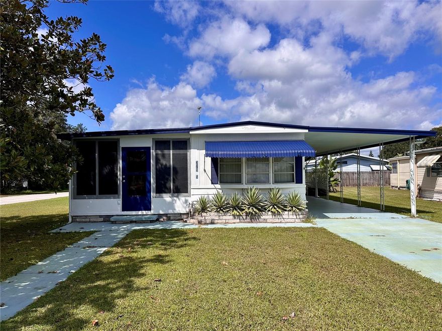 Welcome to this inviting and versatile home in a friendly, all-ages community—no longer restricted to 55+. This property is designed for both comfort and functionality, featuring an expansive Florida room that’s perfect for relaxing or hosting gatherings, along with a bonus room that can easily serve as a guest bedroom, home office, or hobby space.

If storage is a priority, this home has you covered inside and out. The unique outdoor storage area includes a washer, dryer, and even an additional shower—an ideal setup for convenience and flexibility. Inside, a double pantry offers abundant space for those who love cooking and entertaining.

The home comes fully furnished, making it truly move-in ready. A spacious carport provides plenty of parking for multiple vehicles and doubles as an excellent space for outdoor entertaining. Nestled on a desirable corner lot at the end of a peaceful cul-de-sac, the property provides added privacy and room to enjoy.

Unwind at day’s end on the cozy west-facing porch, the perfect spot to take in stunning sunsets. The Florida room flows seamlessly into the open living area and kitchen, creating a welcoming layout ideal for everyday living and entertaining.

Recent updates include a NEW ROOF (January 2025). This property is being sold AS IS for the seller’s convenience and is sure to draw attention quickly. Don’t miss your opportunity to call this spacious, well-appointed home your own and start making lasting memories.